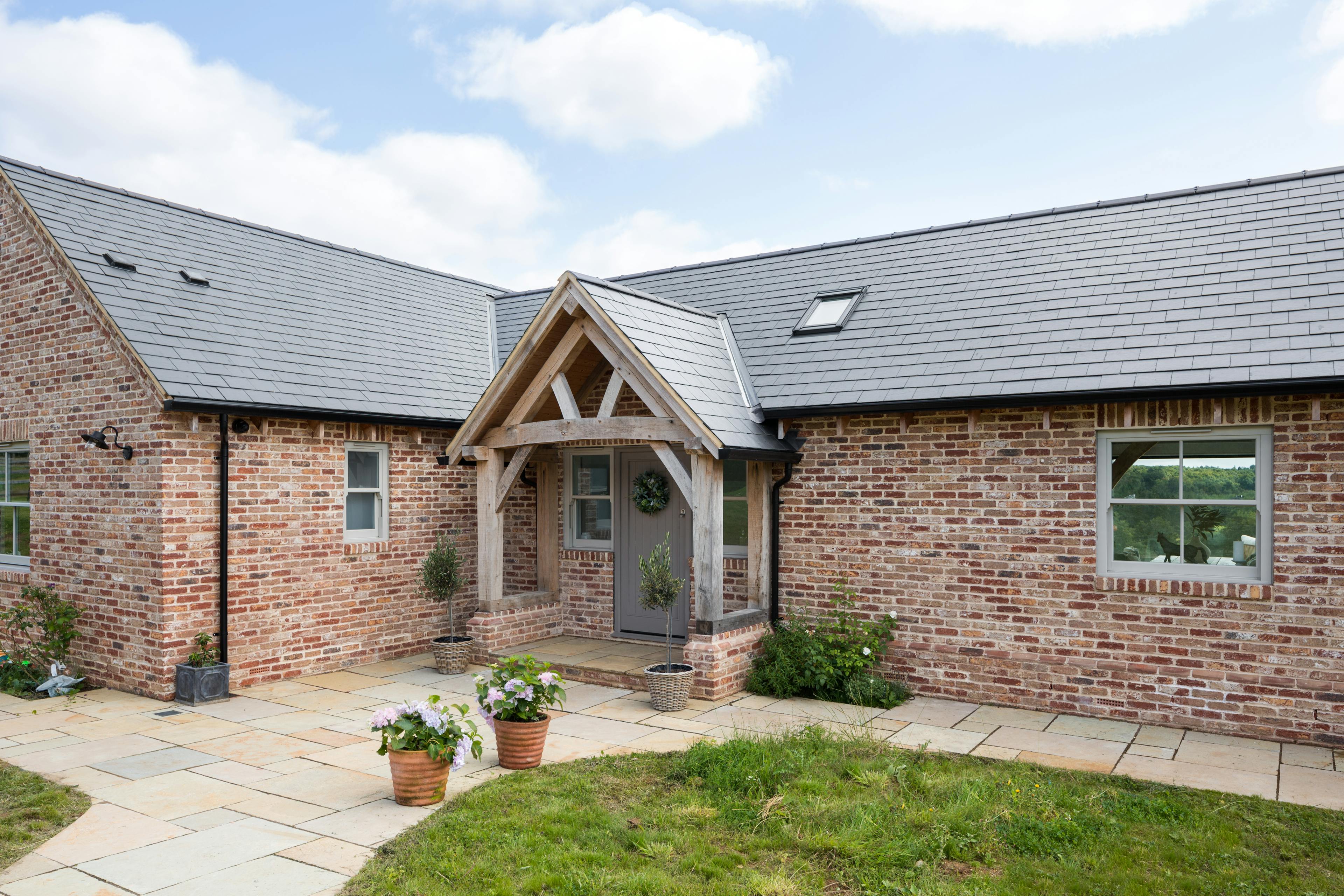 External view of oak framed porch with queen post truss