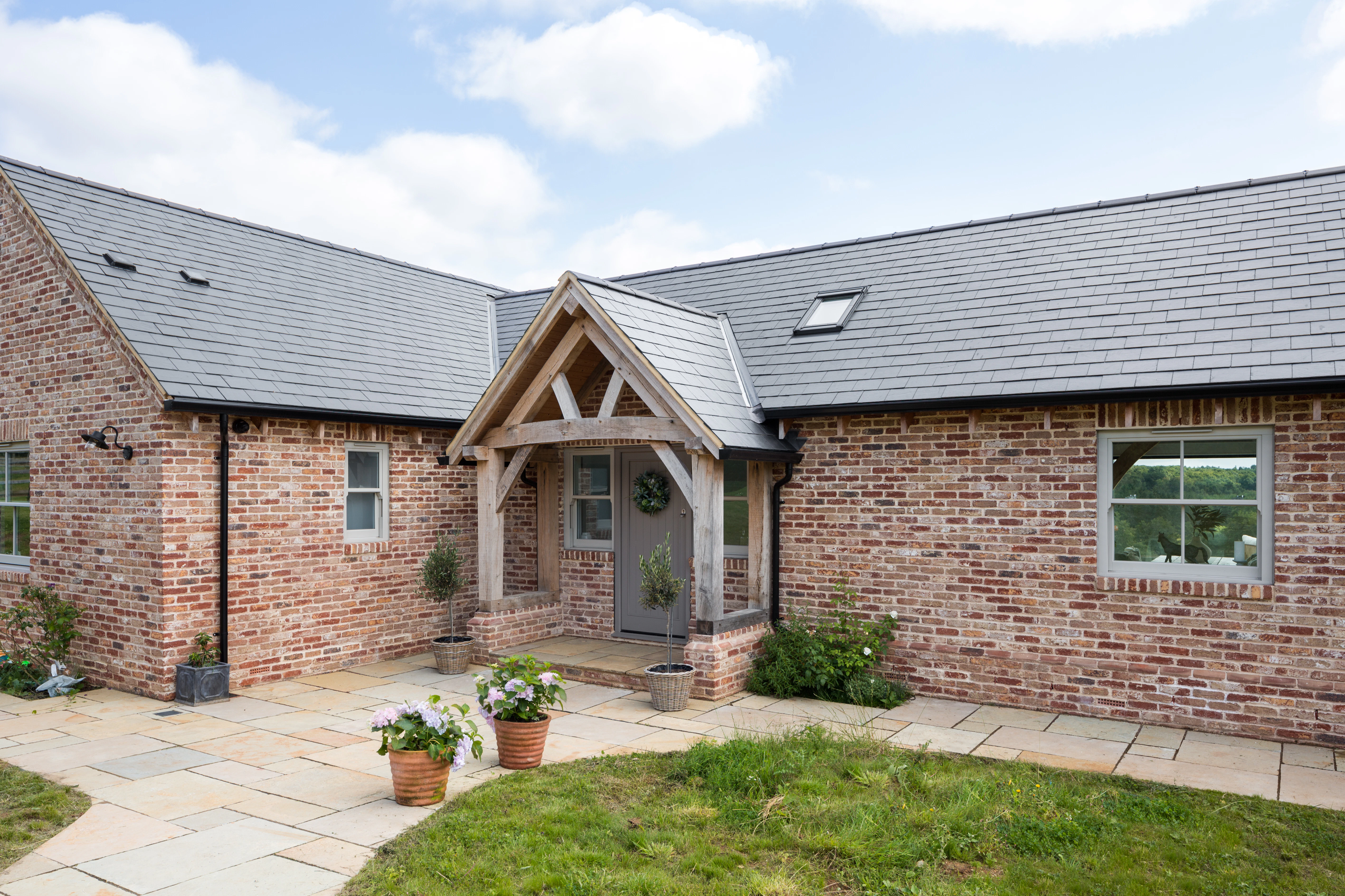 External view of oak framed porch with queen post truss