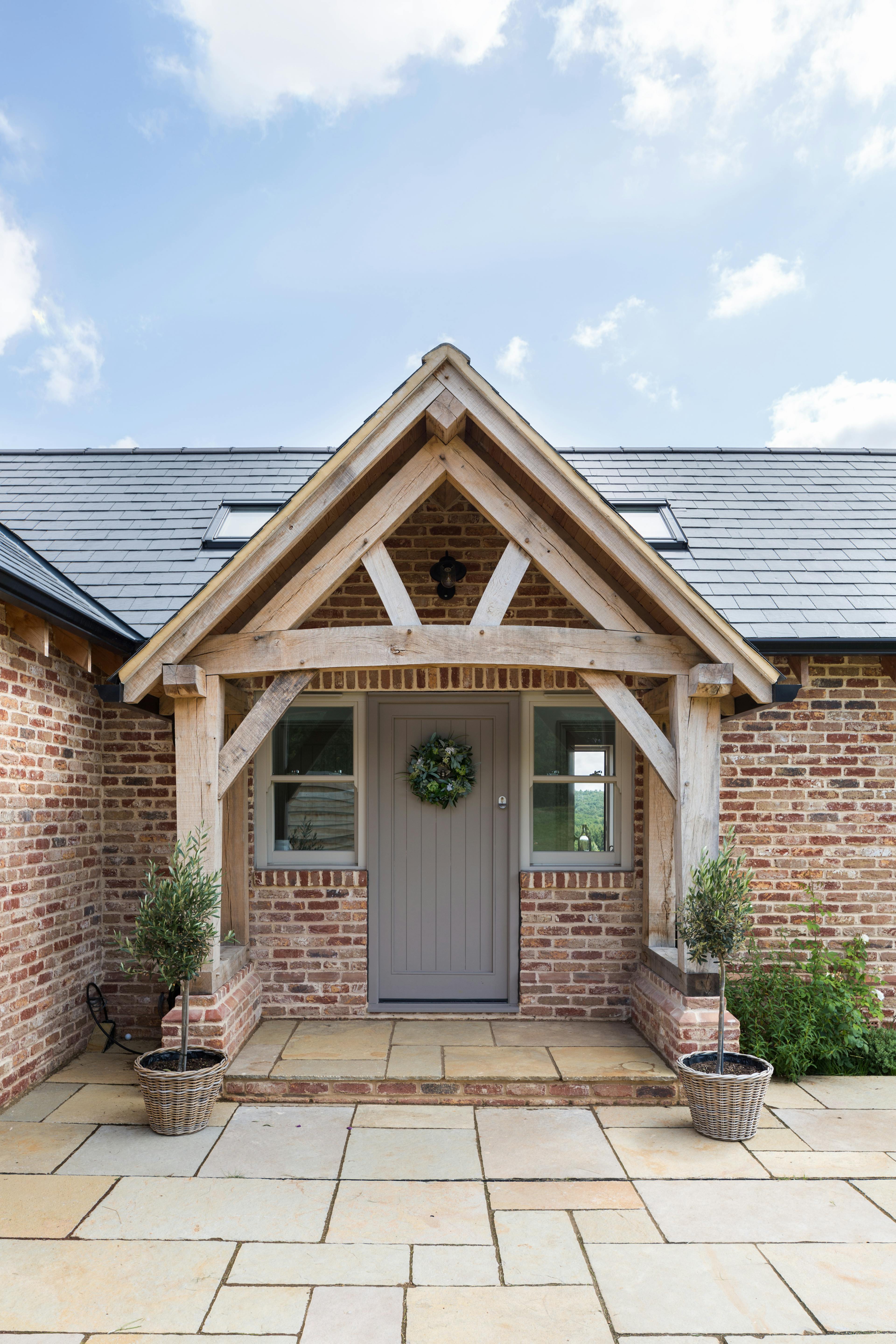 External view of oak framed porch with a queen post truss