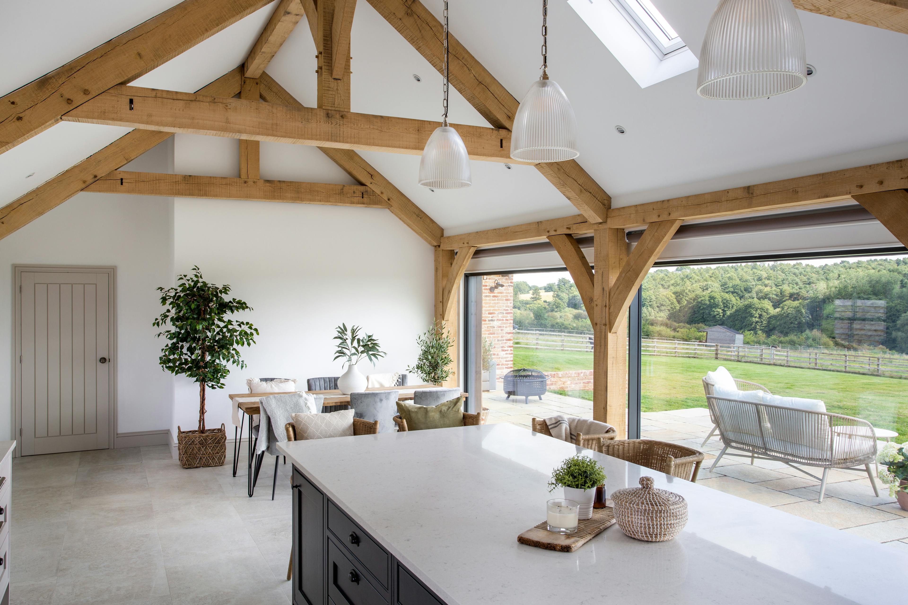 Interior view of an oak-framed kitchen that opens into a spacious dining area