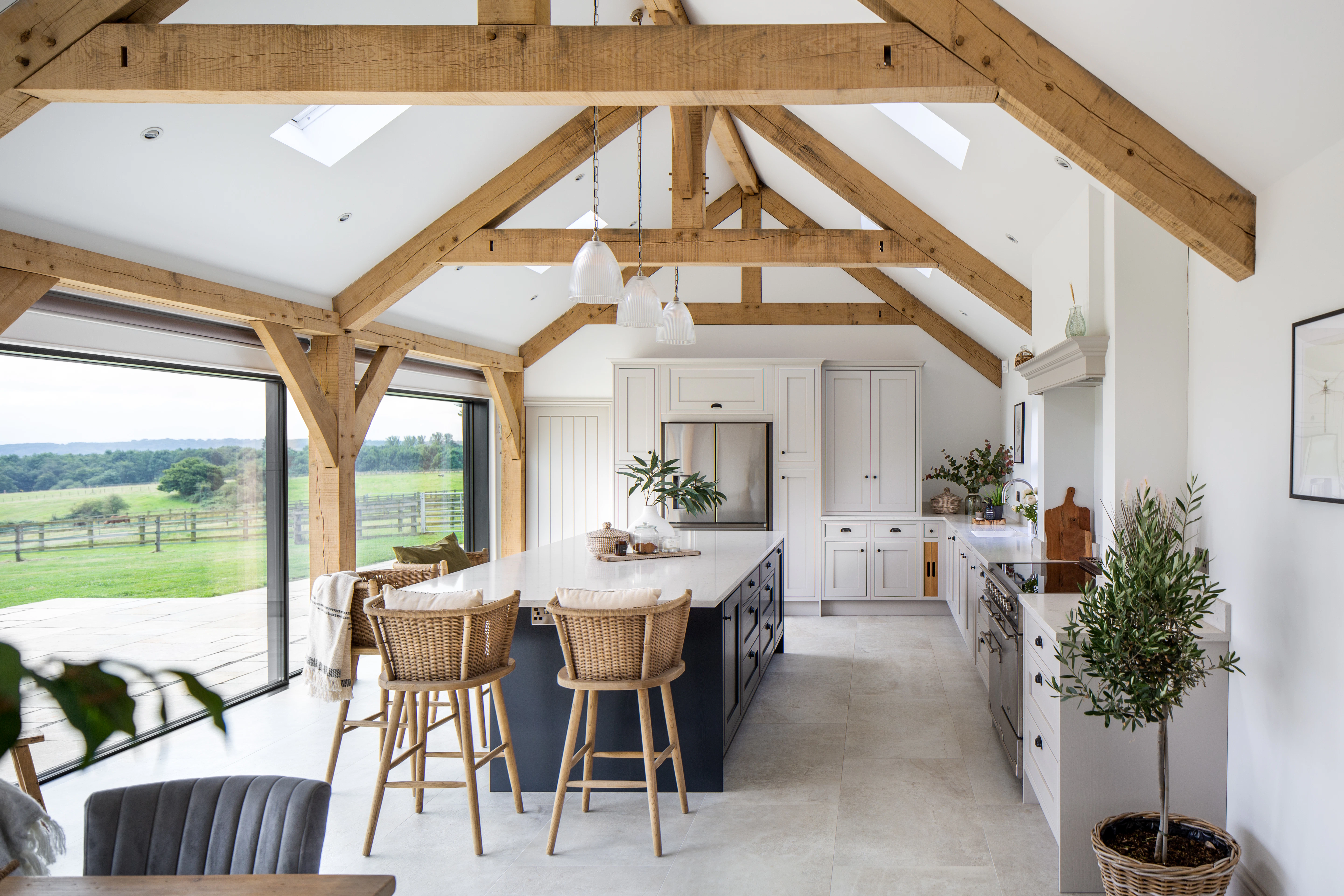 Internal view of oak framed kitchen, minimalist open plan space with functional central island