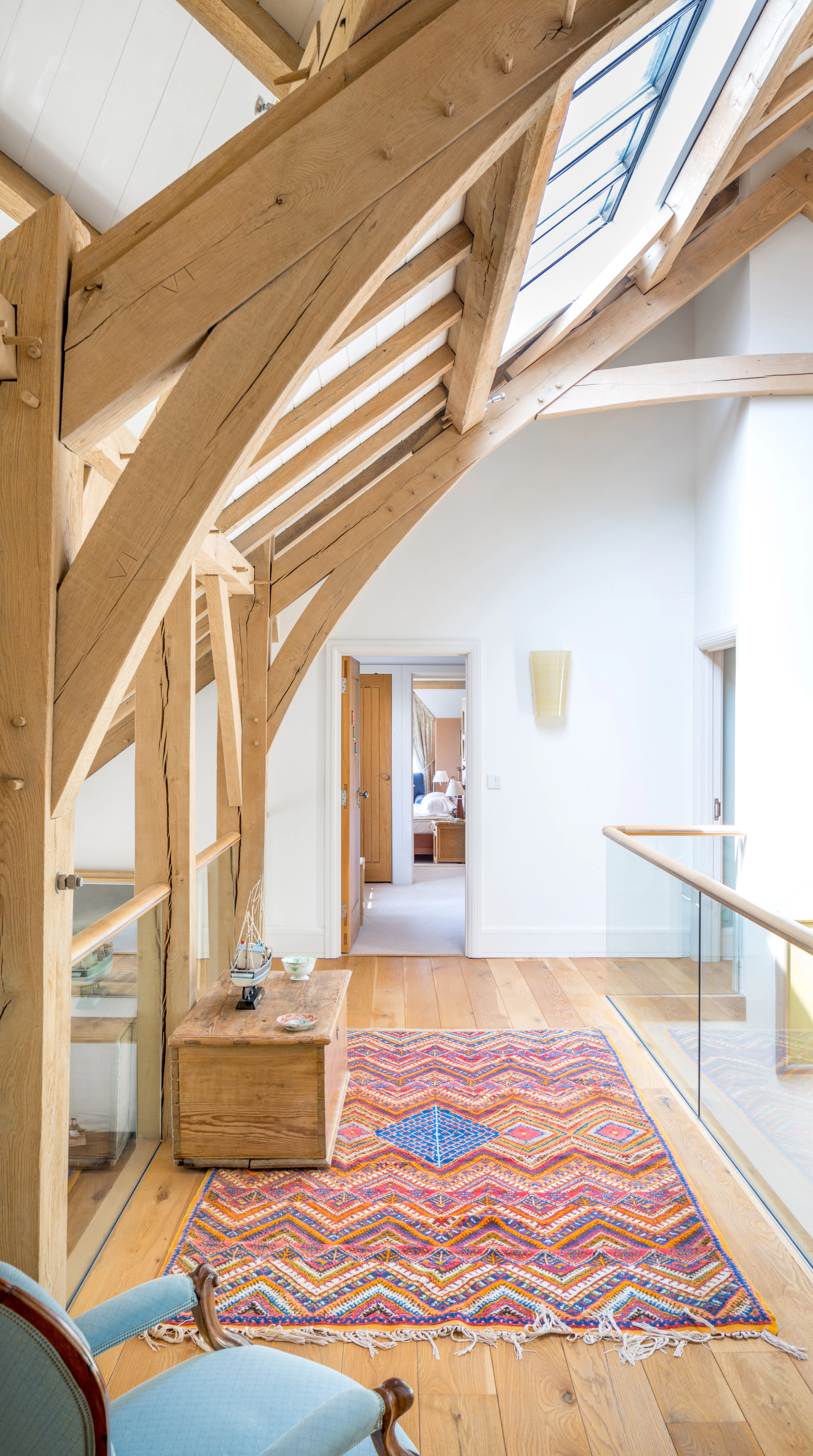 Wrap-around mezzanine in an oak-framed farmhouse, providing access to the bedrooms