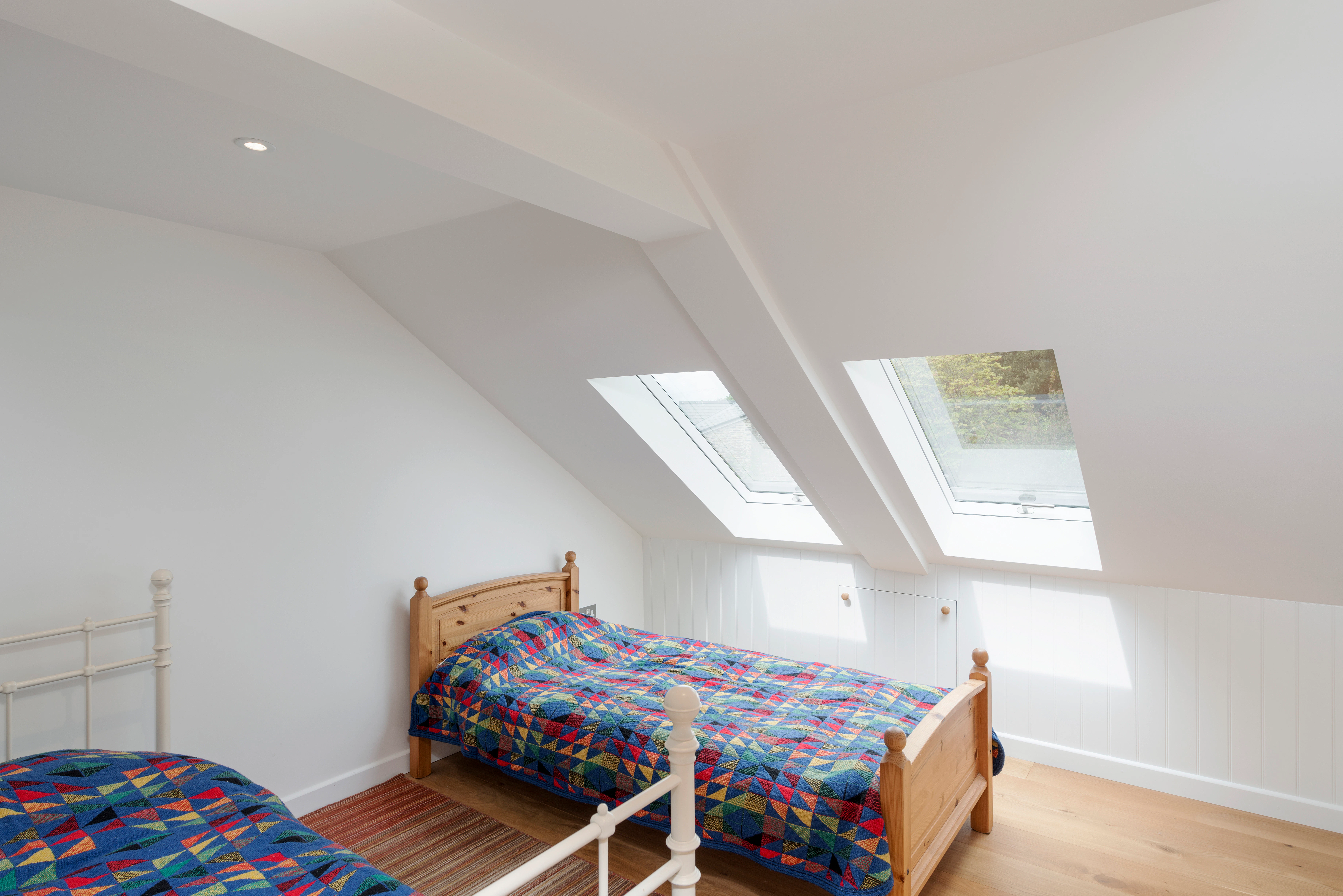 Interior view of a twin bedroom inside a two-story oak-framed home