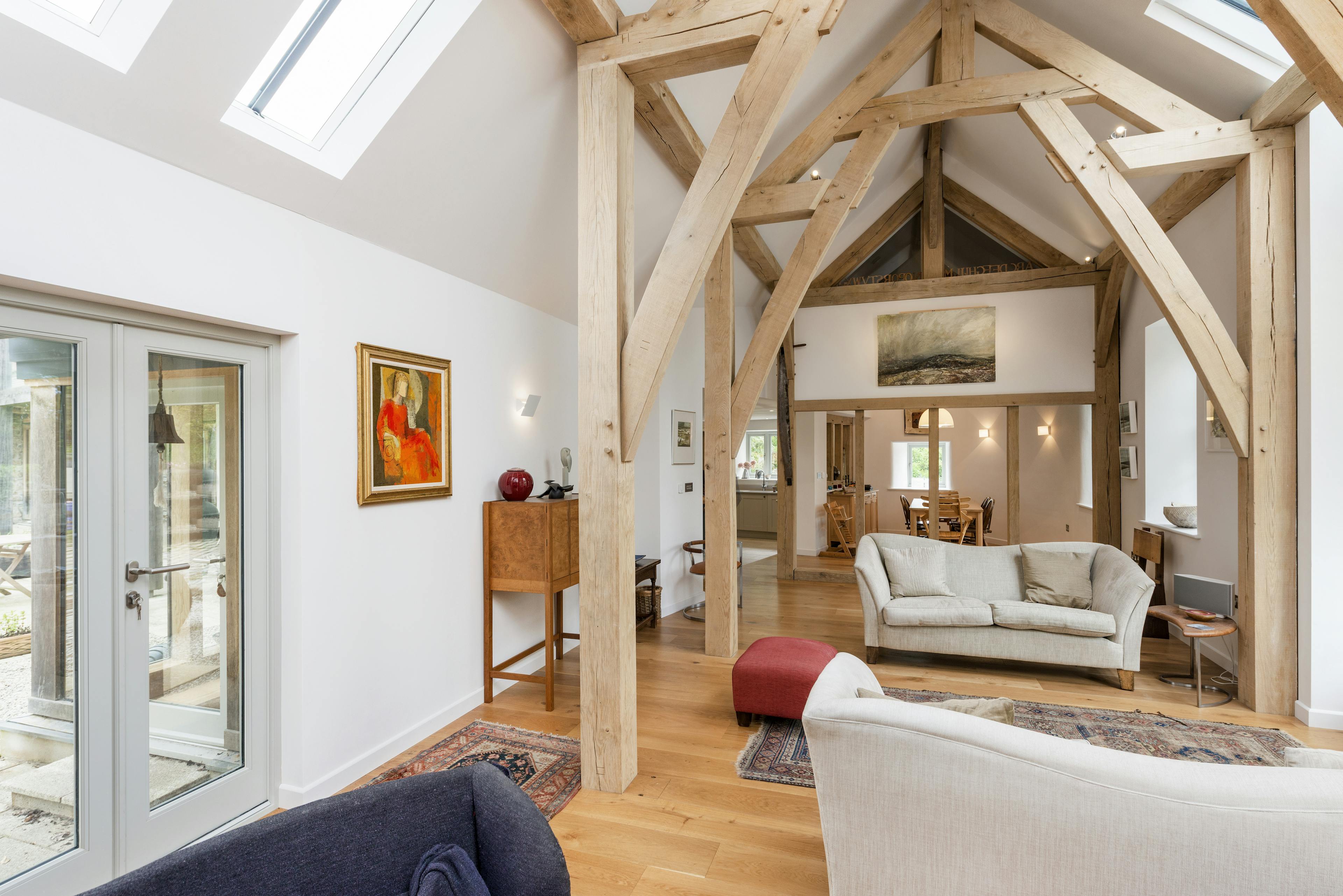 Interior view of an open-plan lounge featuring exposed structural sling brace trusses