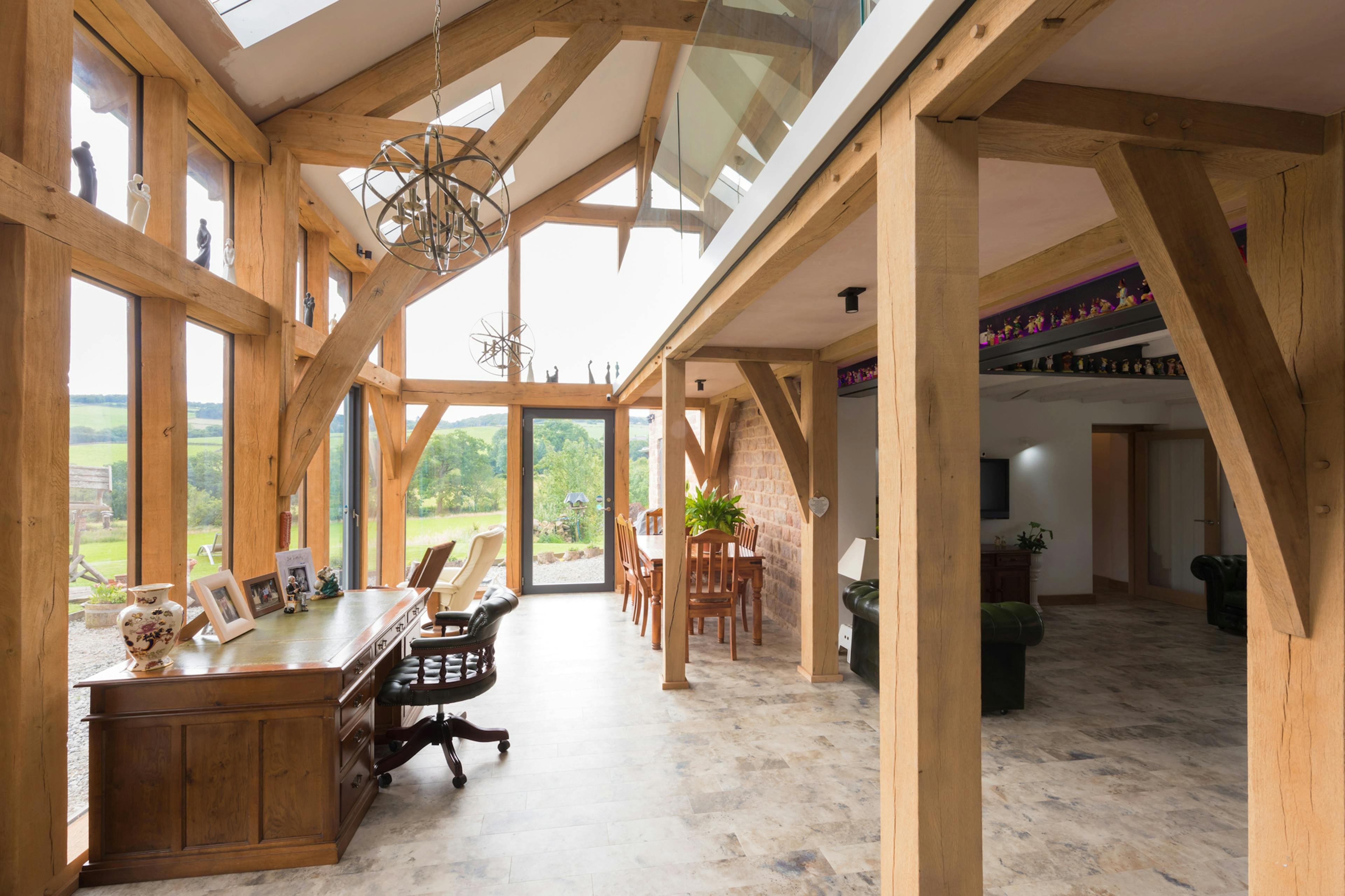 Interior view of an oak-framed open-plan lounge and dining area