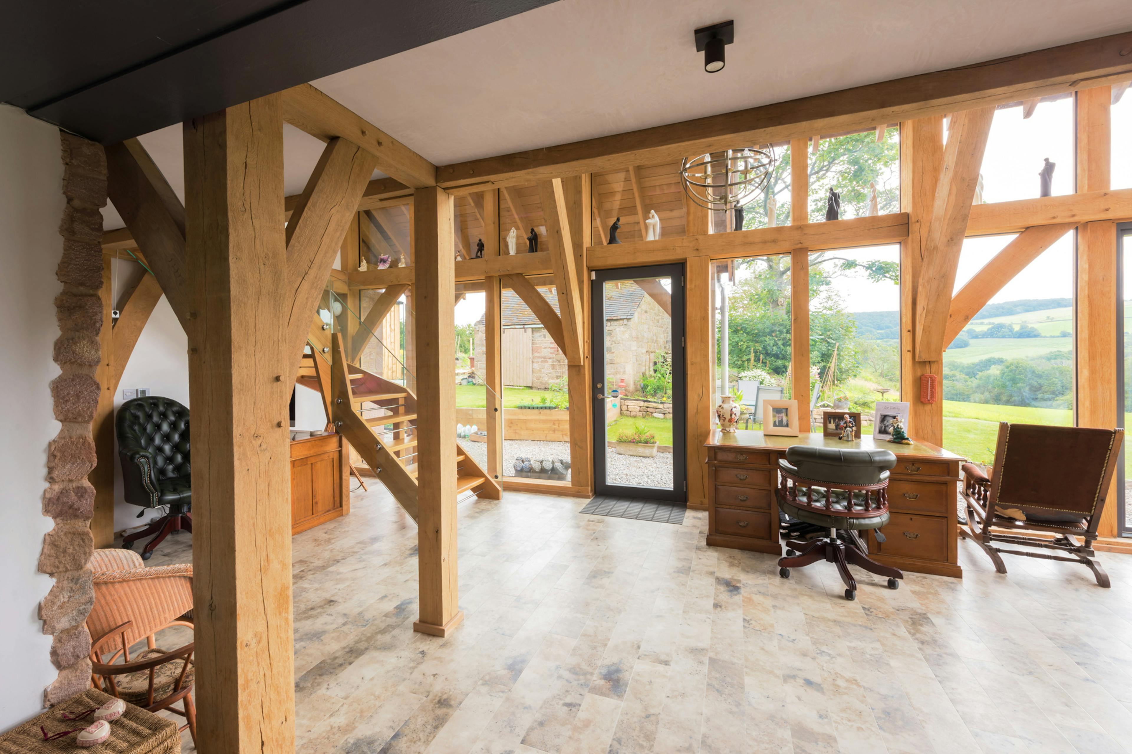 Interior view of a fully glazed, two-story oak-framed open-plan extension