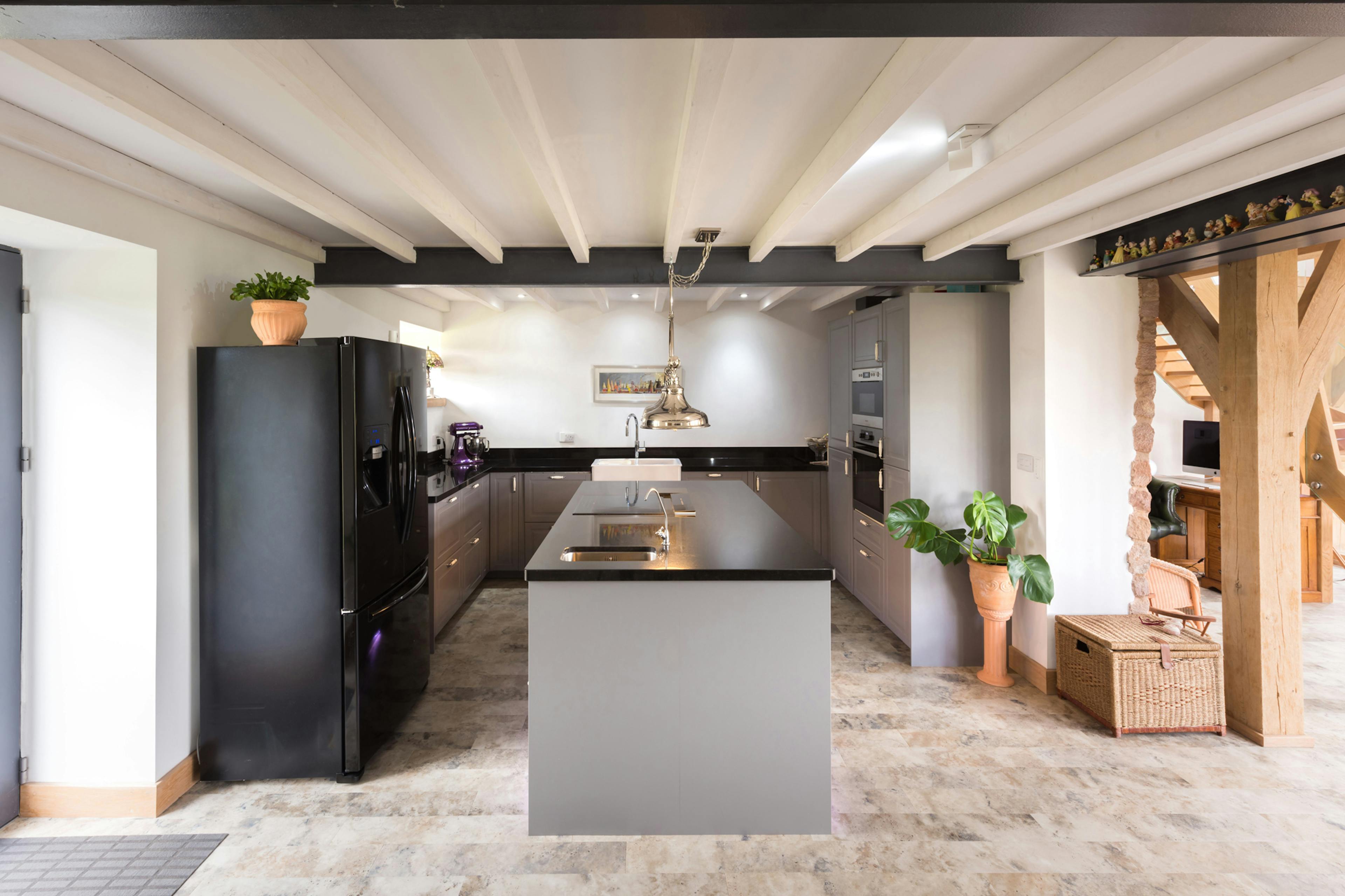 Interior view of a contemporary oak-framed kitchen featuring a central island.