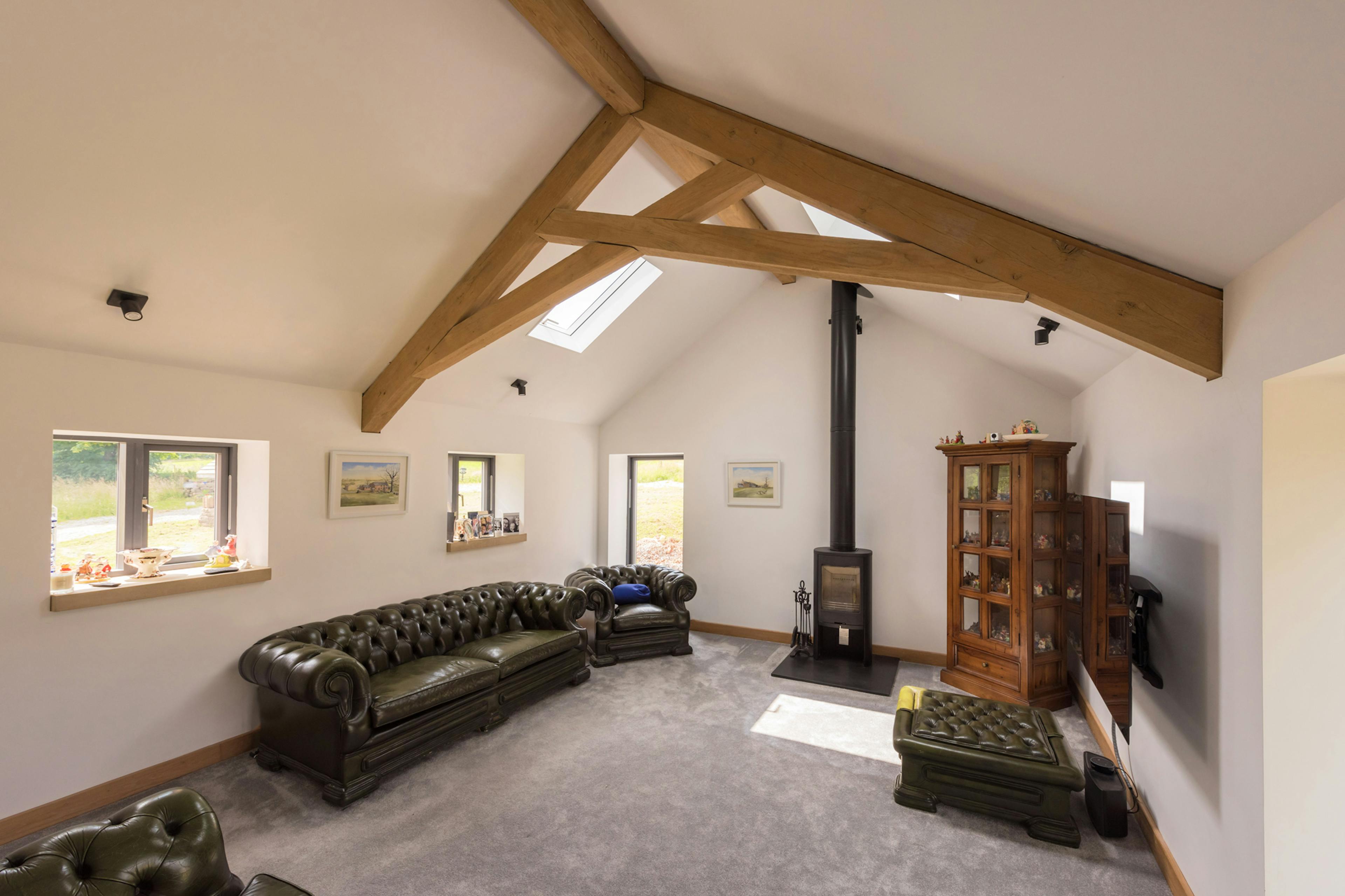 Interior view of a lounge featuring an oak-framed scissor truss