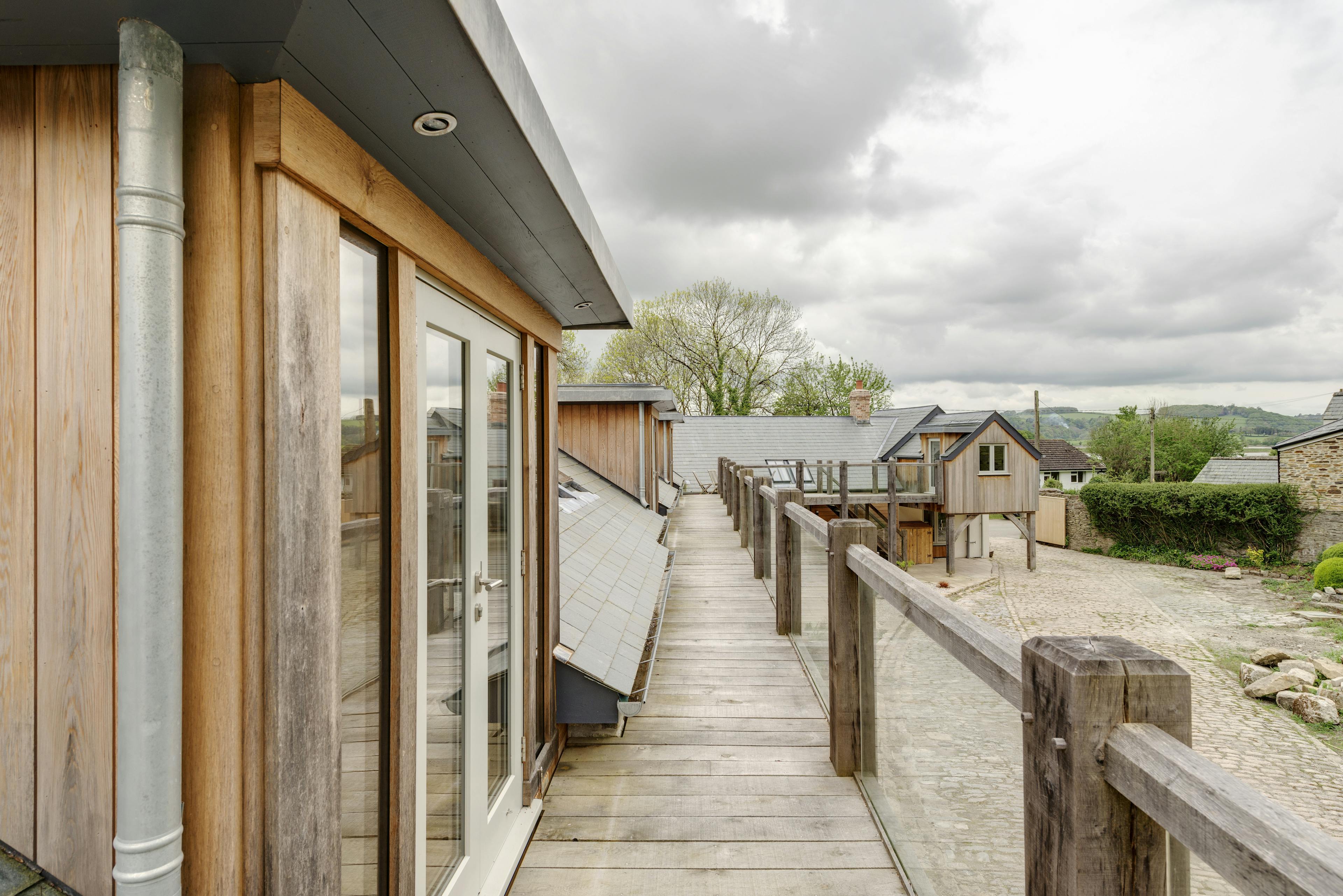Exterior view of a wrap-around balcony with doors leading to the bedrooms