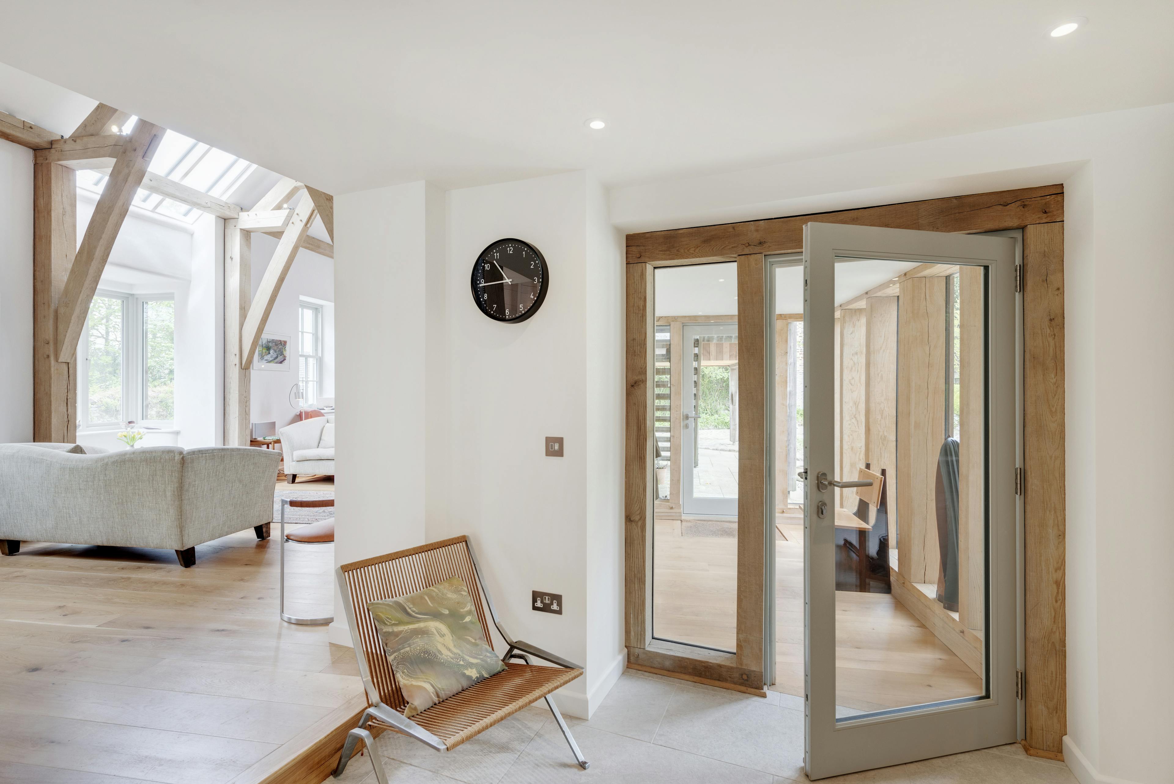 Interior view of a foyer featuring an oak-framed internal door and window with direct glazing
