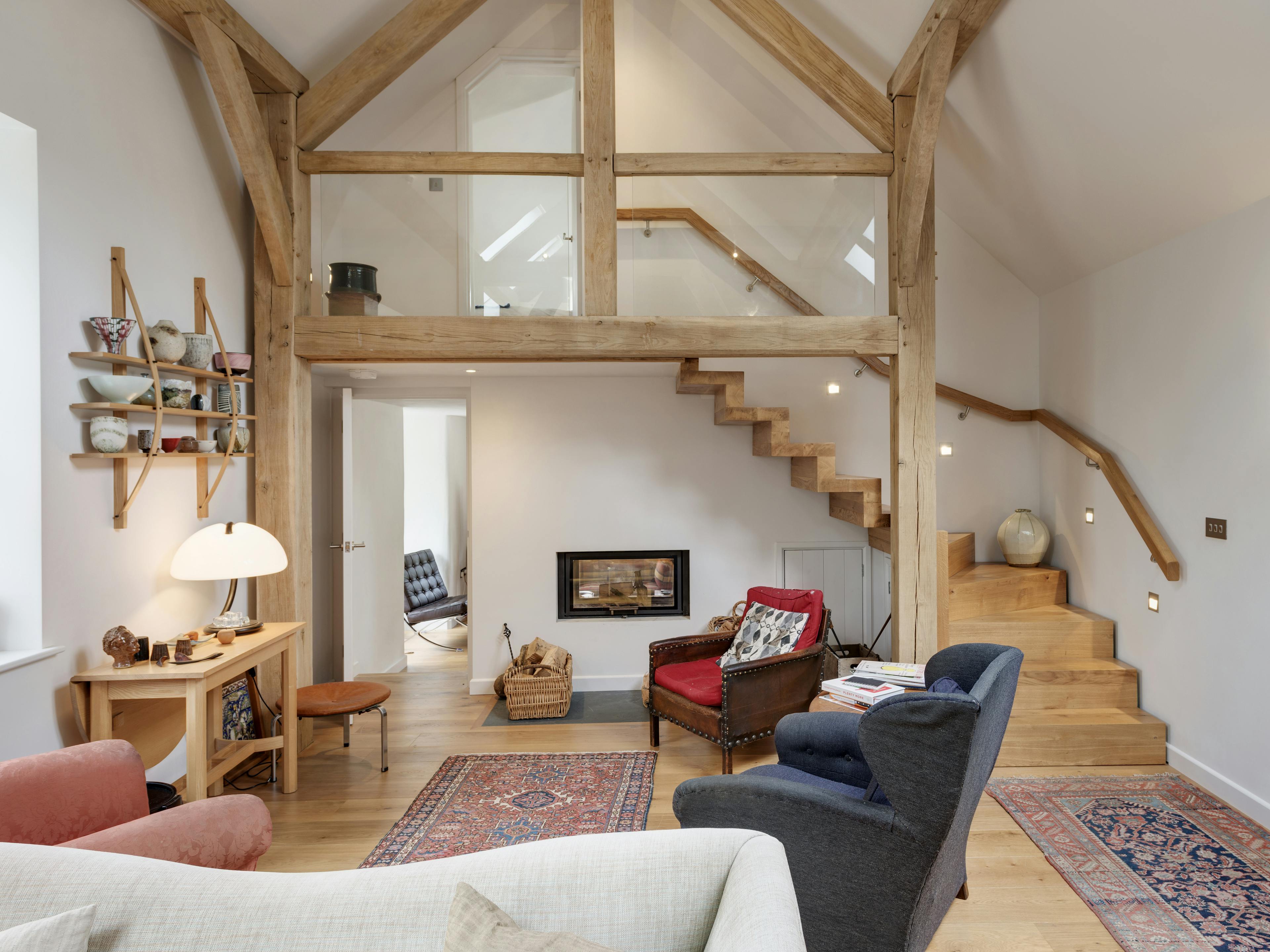 Interior view of a lounge featuring a spiral staircase integrated into a two-story truss structure