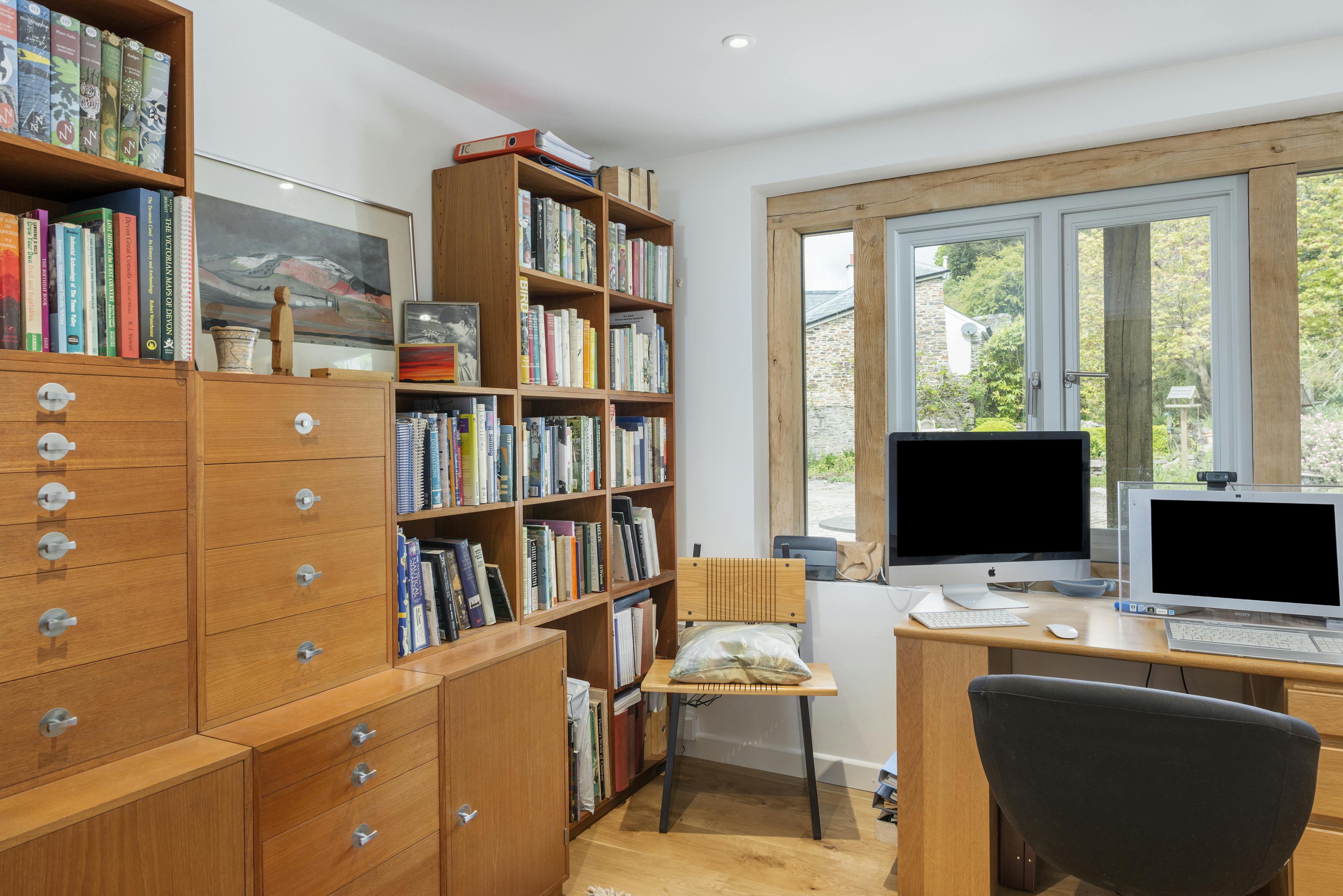 Interior view of an office featuring oak-framed, direct-glazed windows that enhance the natural light