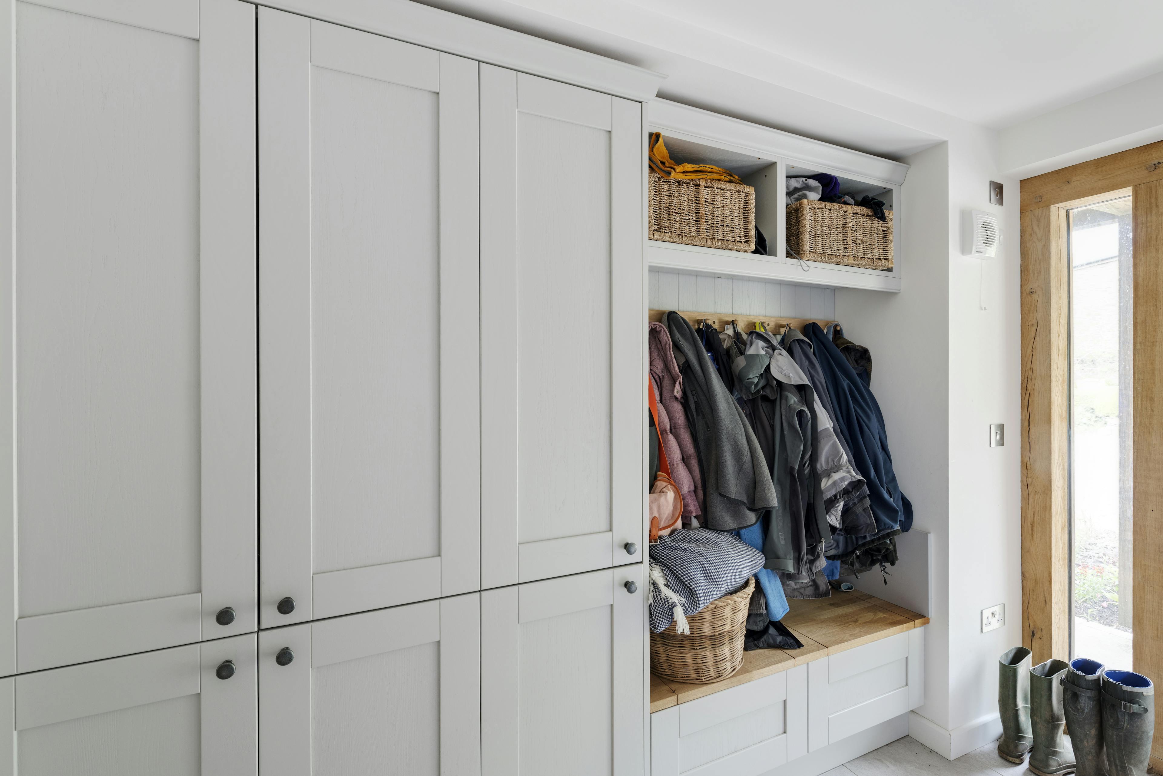 Interior view of an oak-framed porch featuring custom-built storage