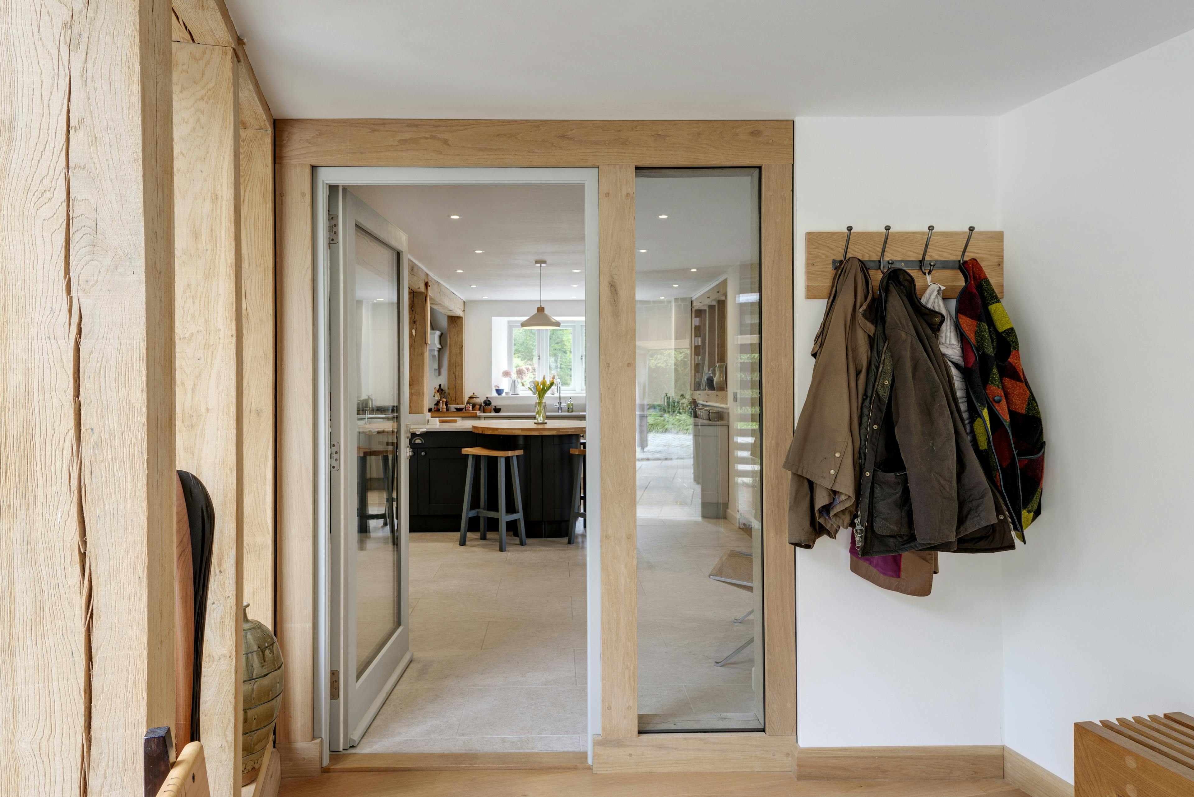 Detailed interior view of a direct-glazed oak-framed door and window in the porch area