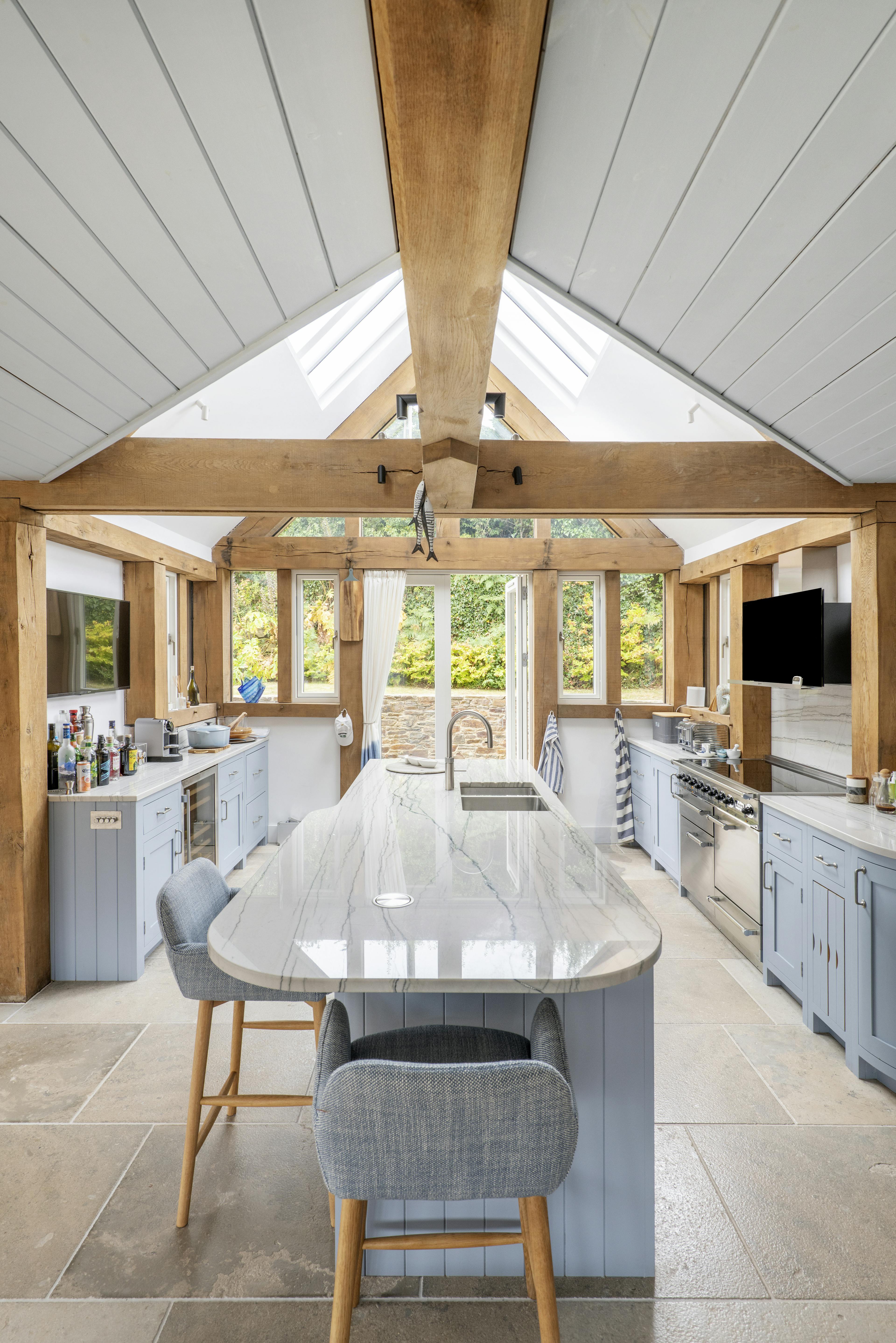 A modern, light, well-finished oak frame kitchen with a large island and a rooflight