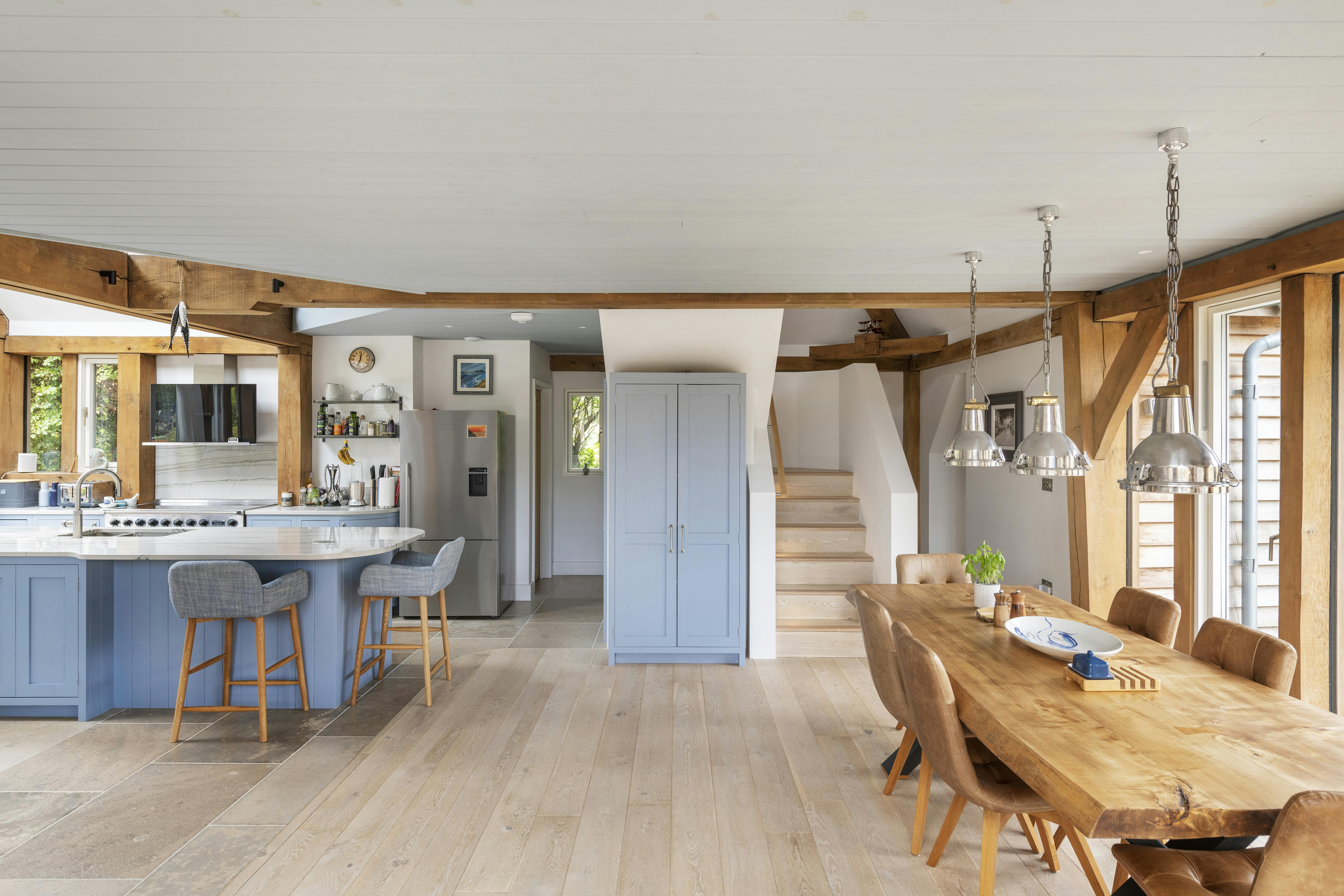 A modern, light filled oak framed home, showing an open plan dining area and kitchen