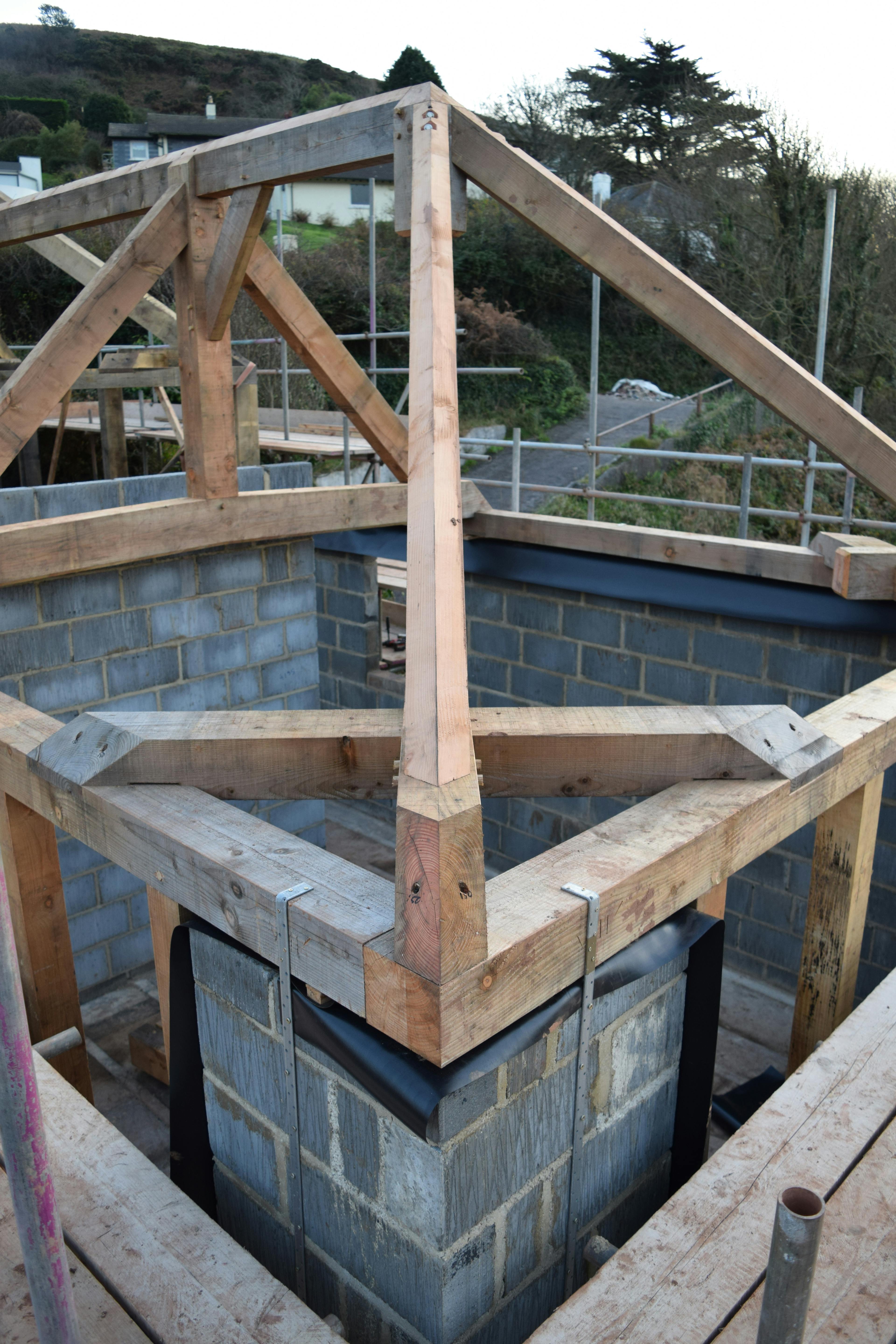 An oak frame being installed on a building site