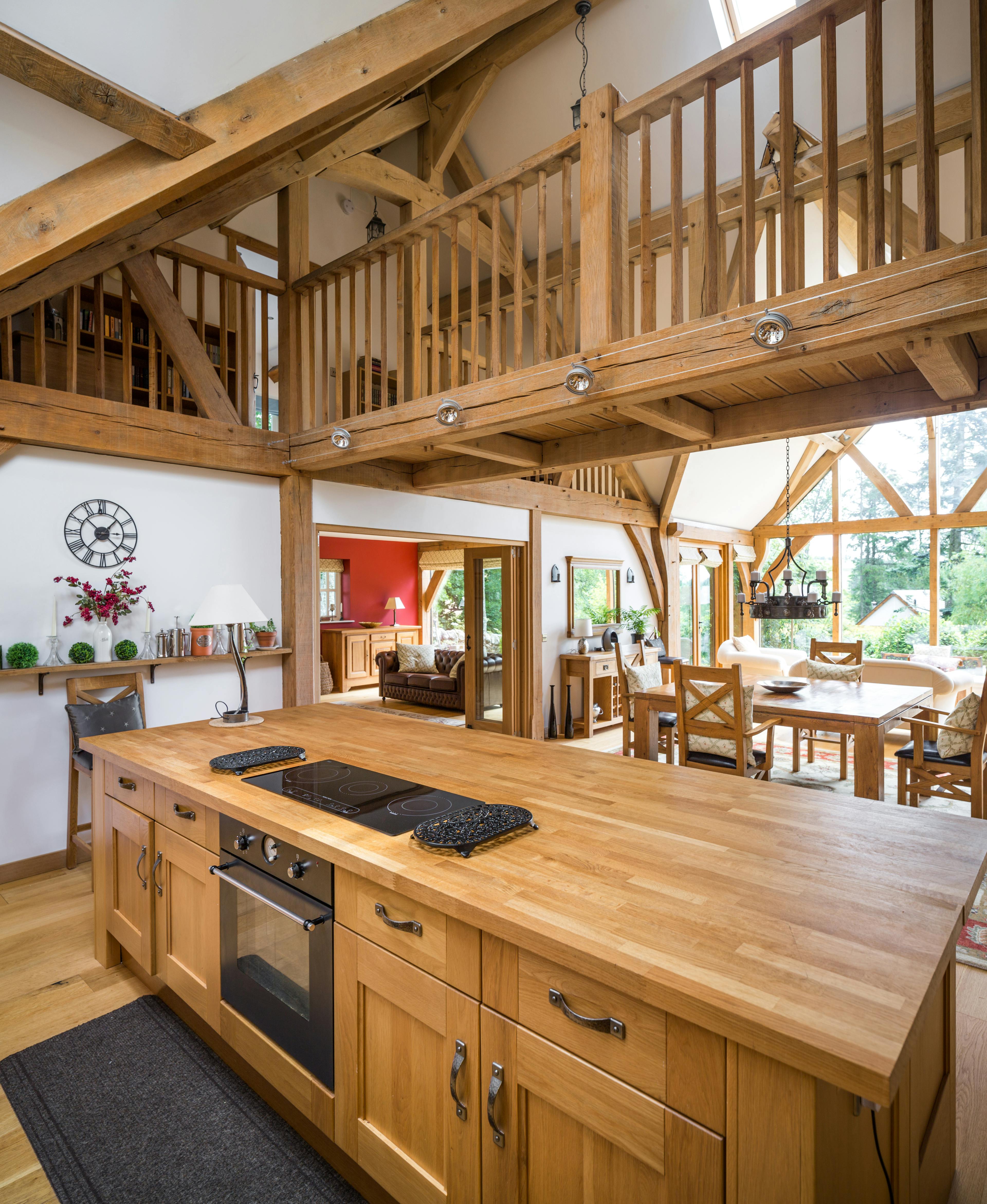 Oak framed kitchen and dining area with a wooden linking bridge above