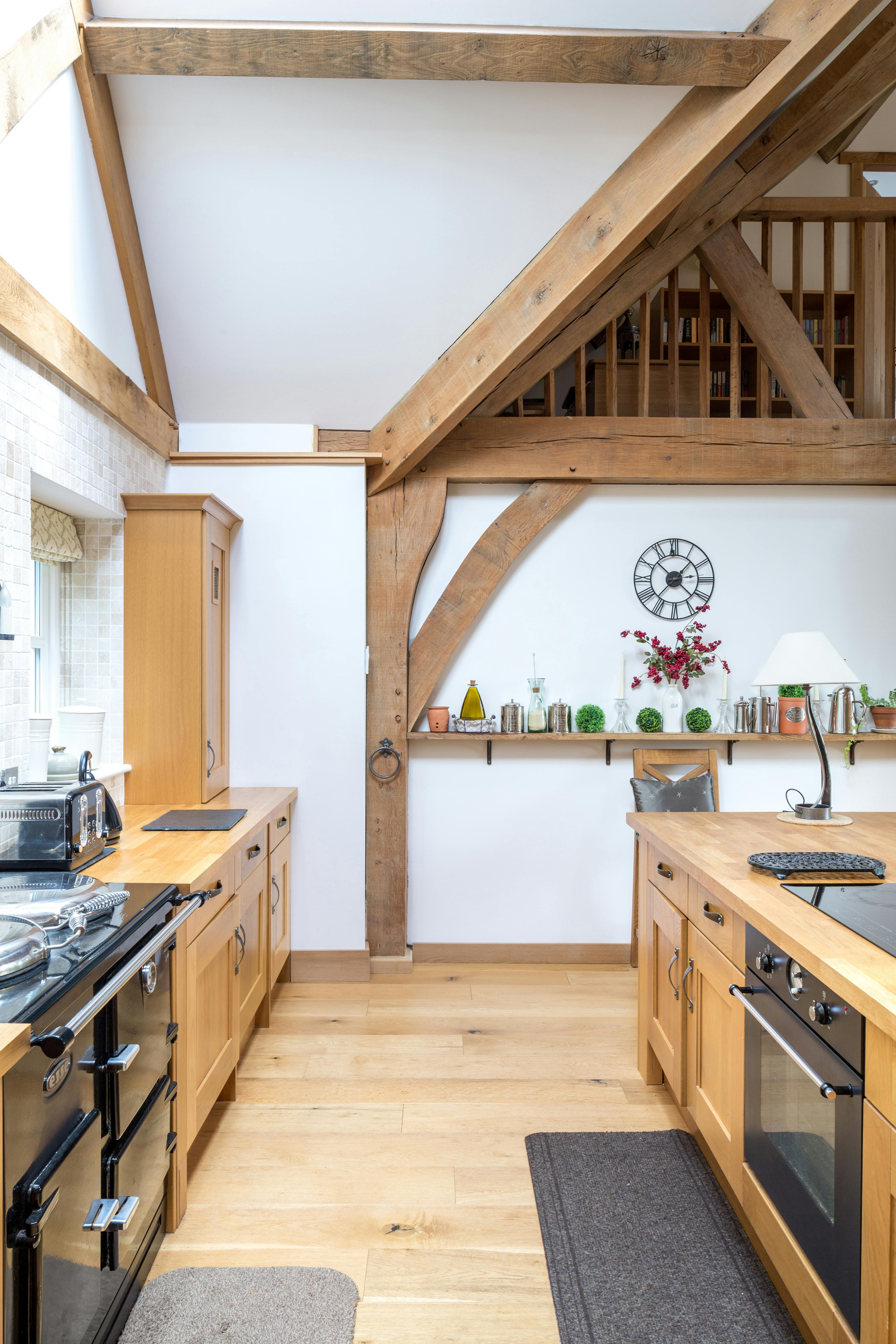 An oak framed kitchen with black aga range