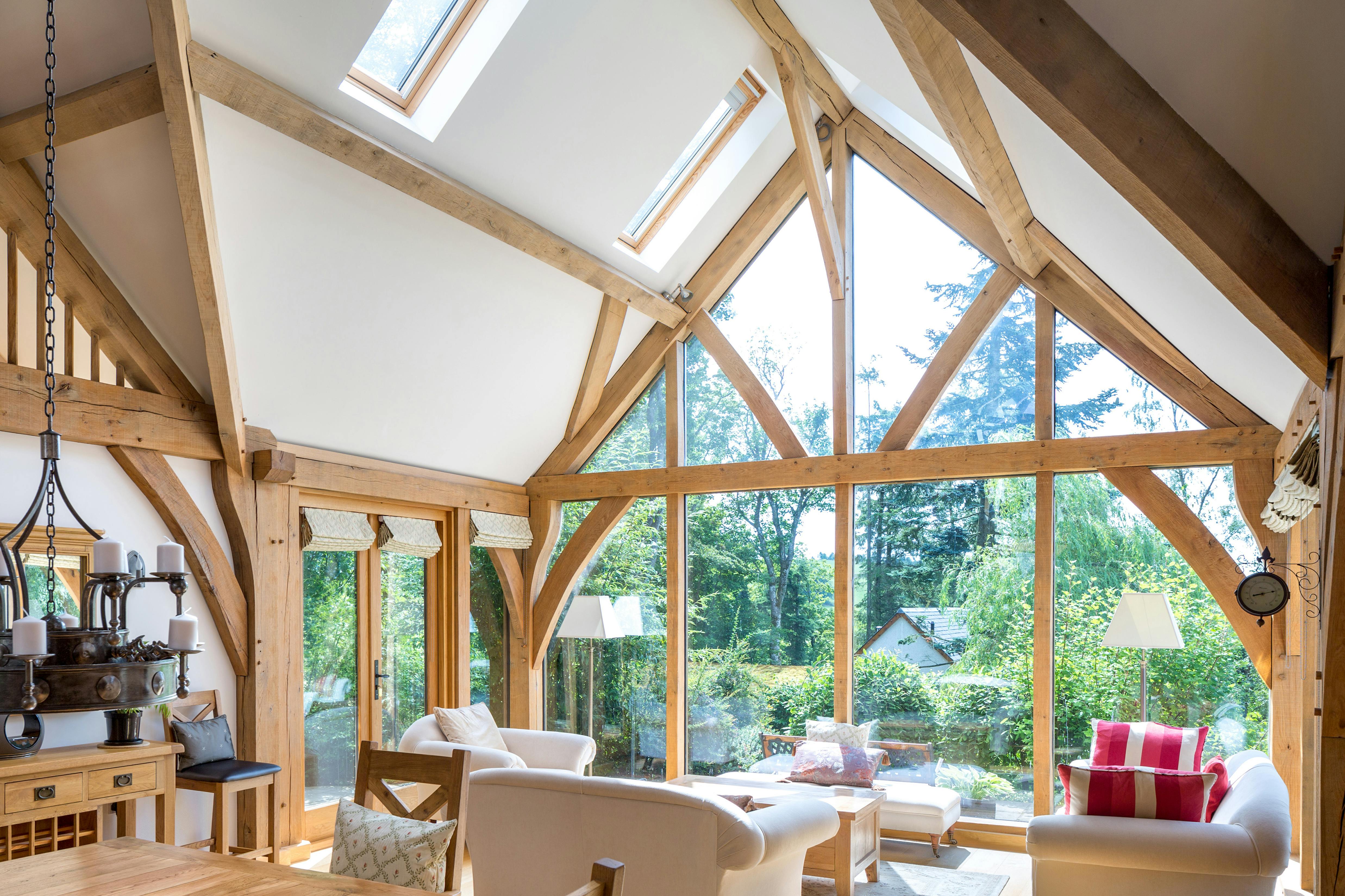 Oak framed living room with a large glazed gable end sitting area and dining table