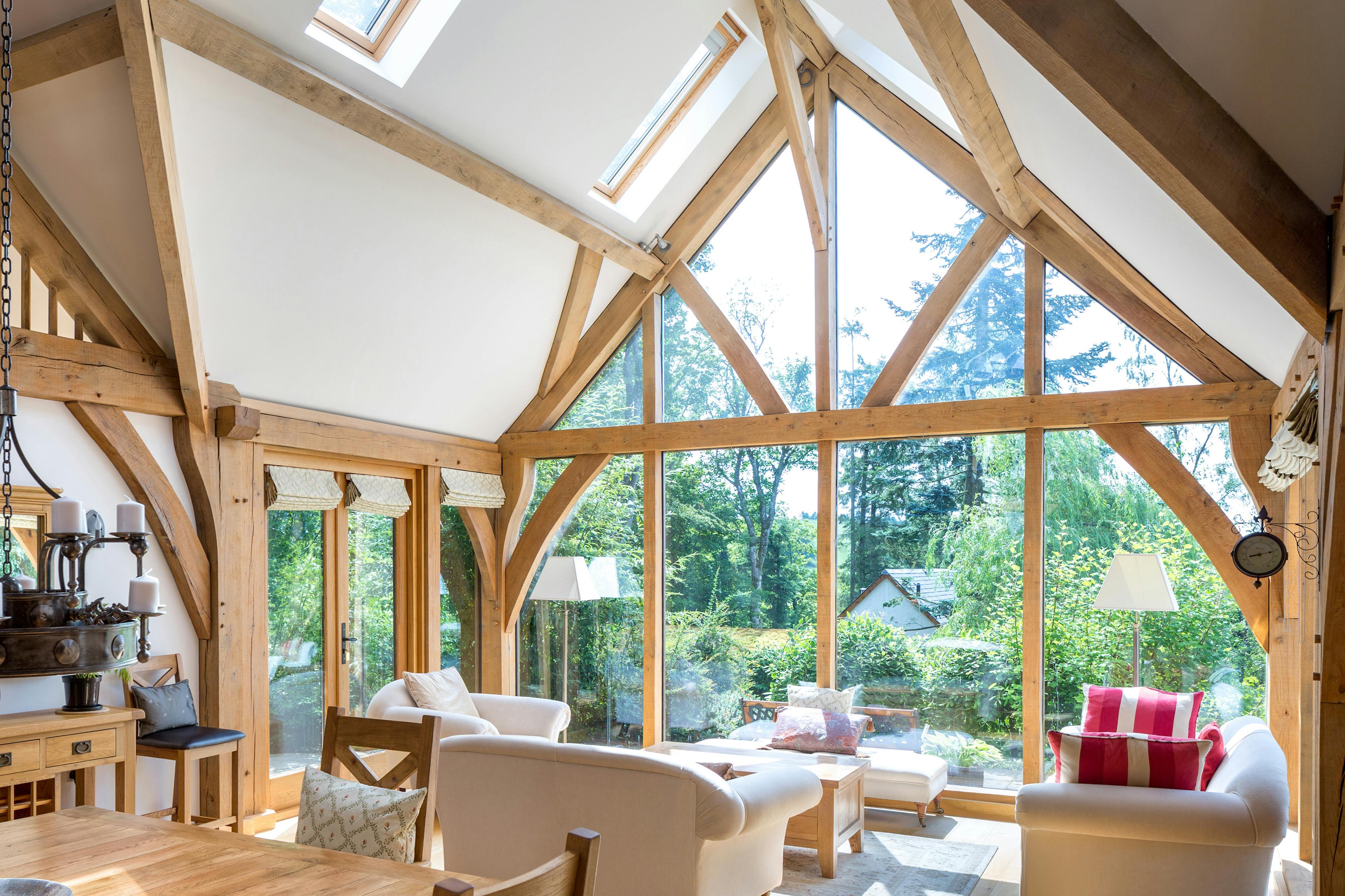Oak framed living room with a large glazed gable end sitting area and dining table