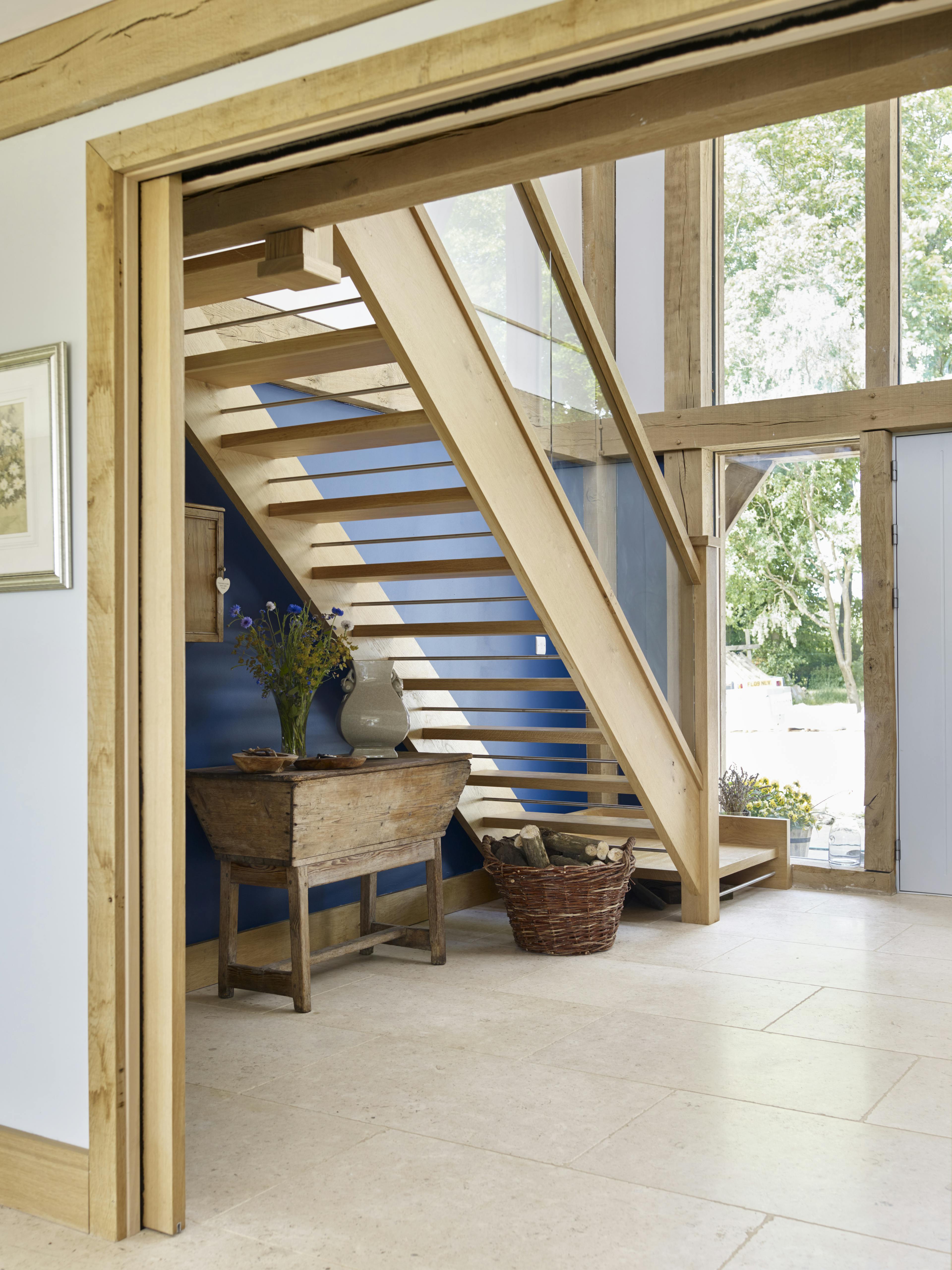 An oak framed entrance hall with a wooden staircase