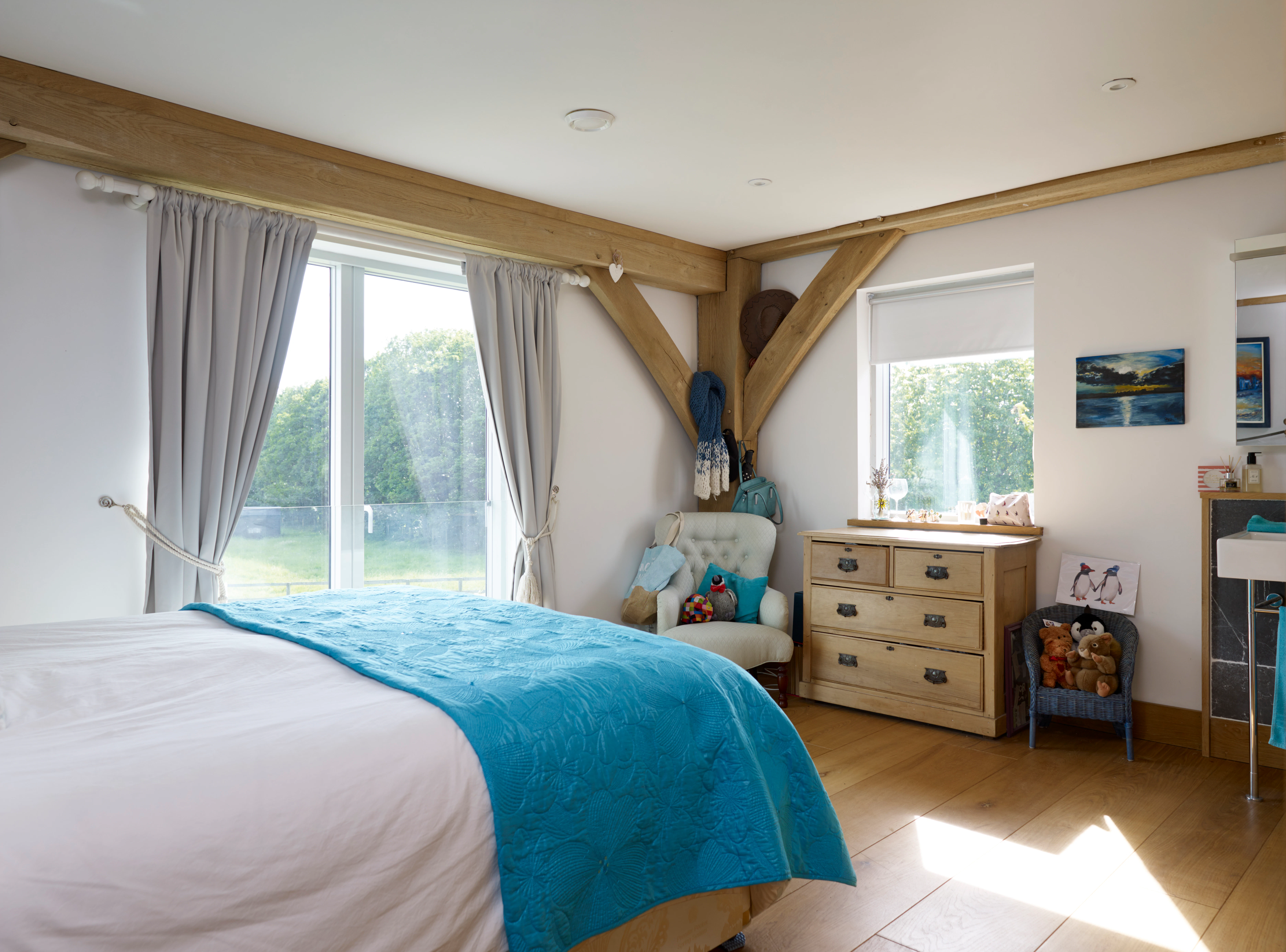 An oak framed bedroom with sliding doors to a garden