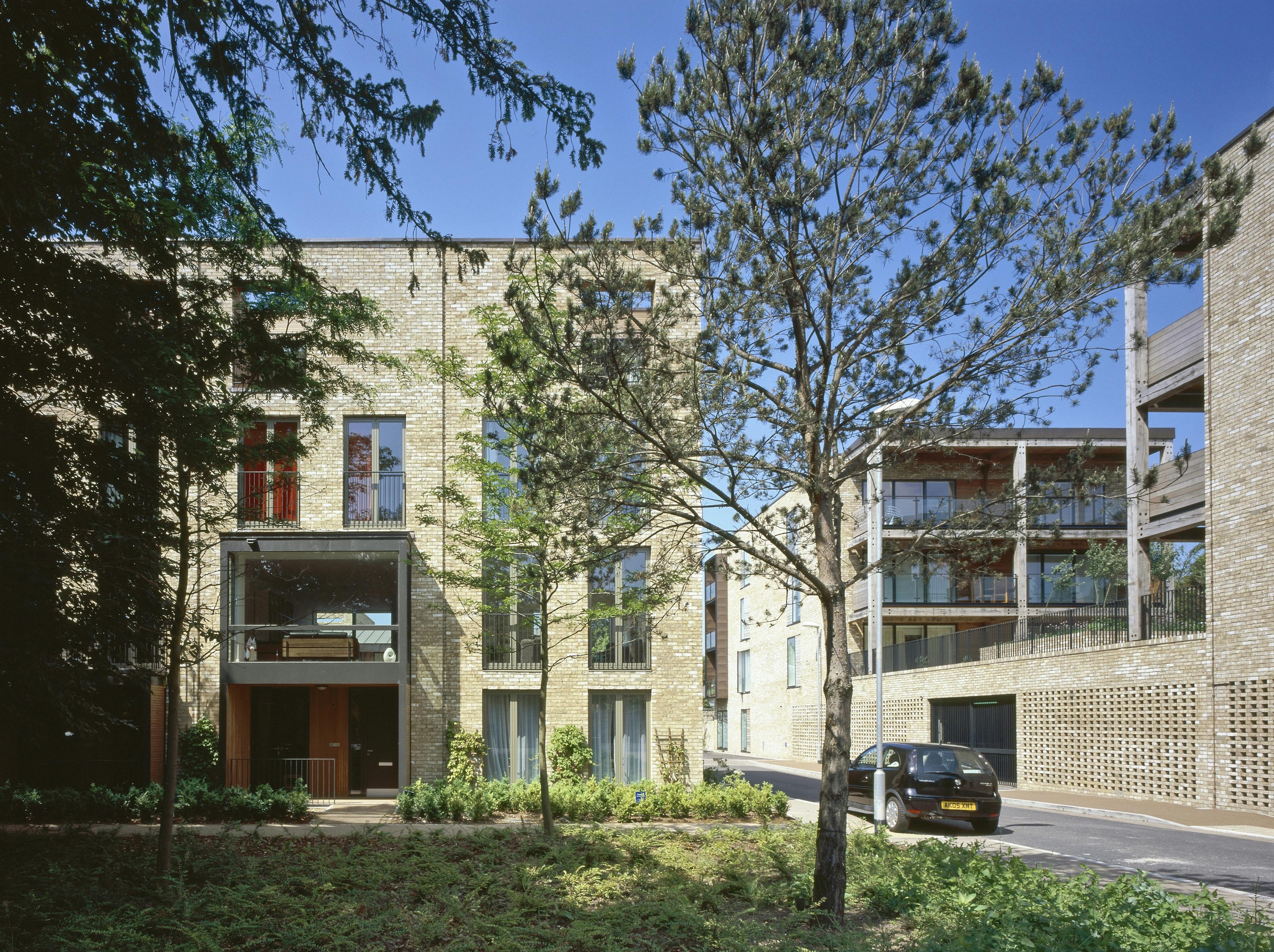 Exterior view of a housing project featuring spacious green oak-framed balconies secured with steel fixings