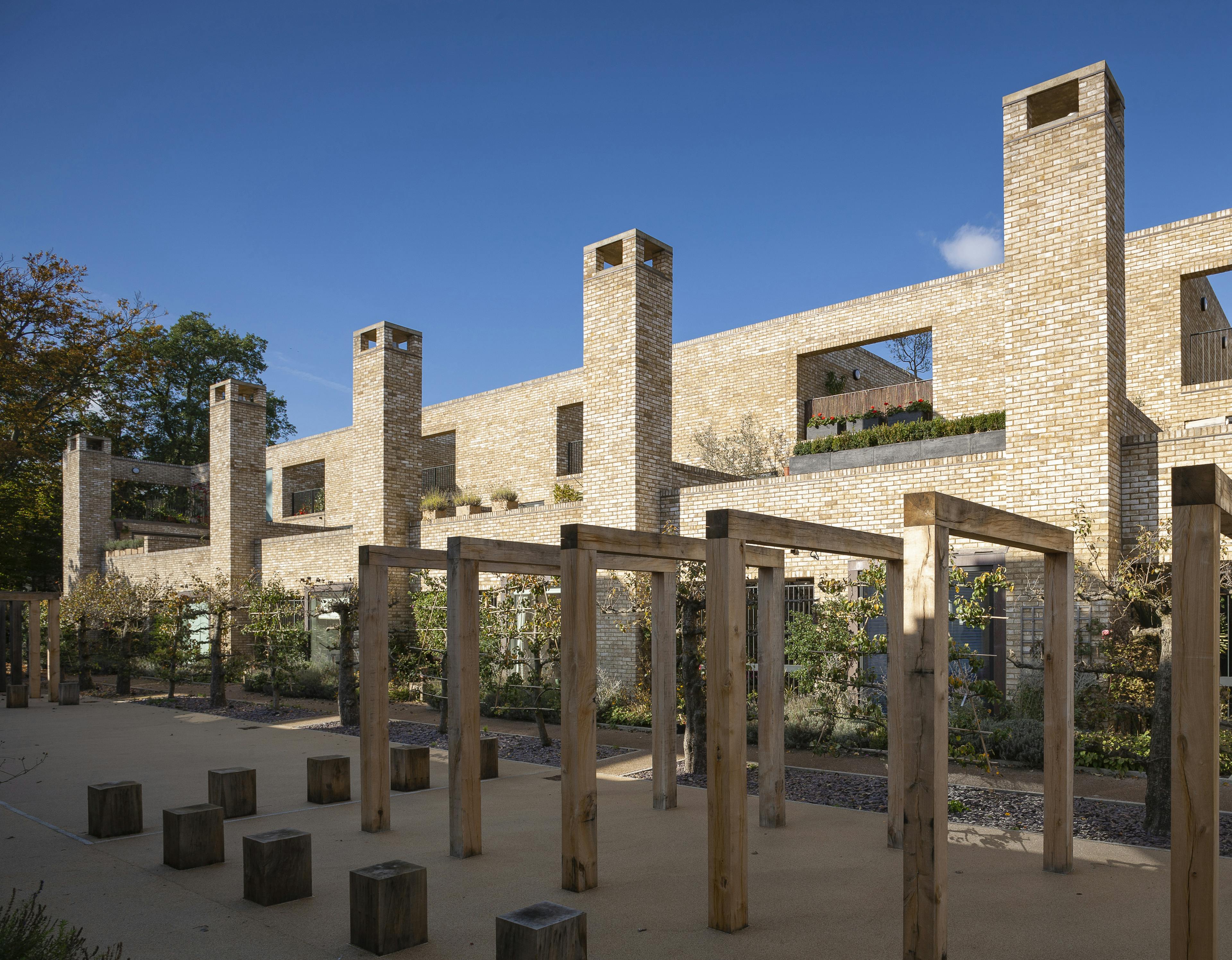 Exterior view of contemporary houses and apartments with oak-framed pergolas in a courtyard garden