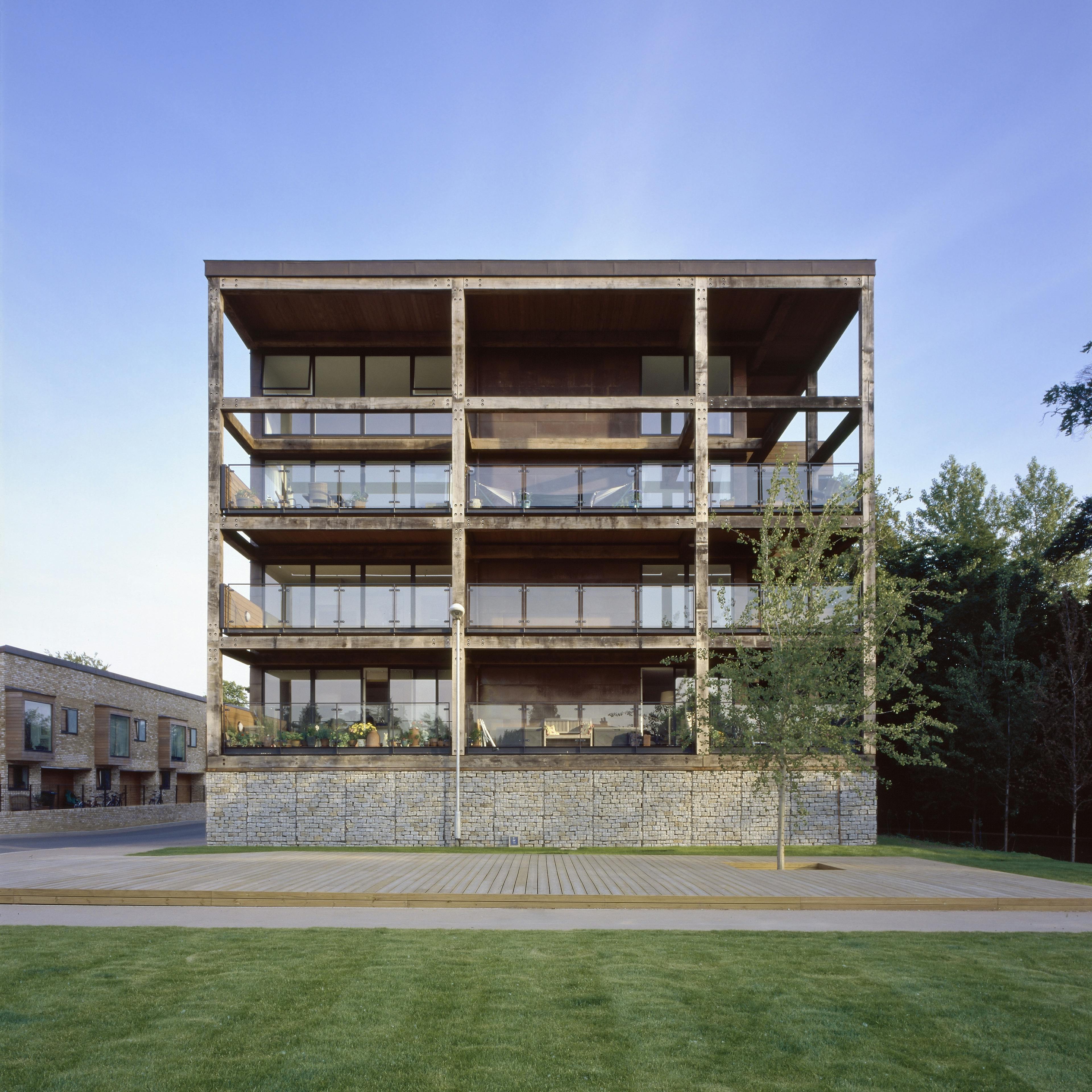 Exterior view of an apartment block featuring oak-framed, glazed balconies secured with steel flitch plates
