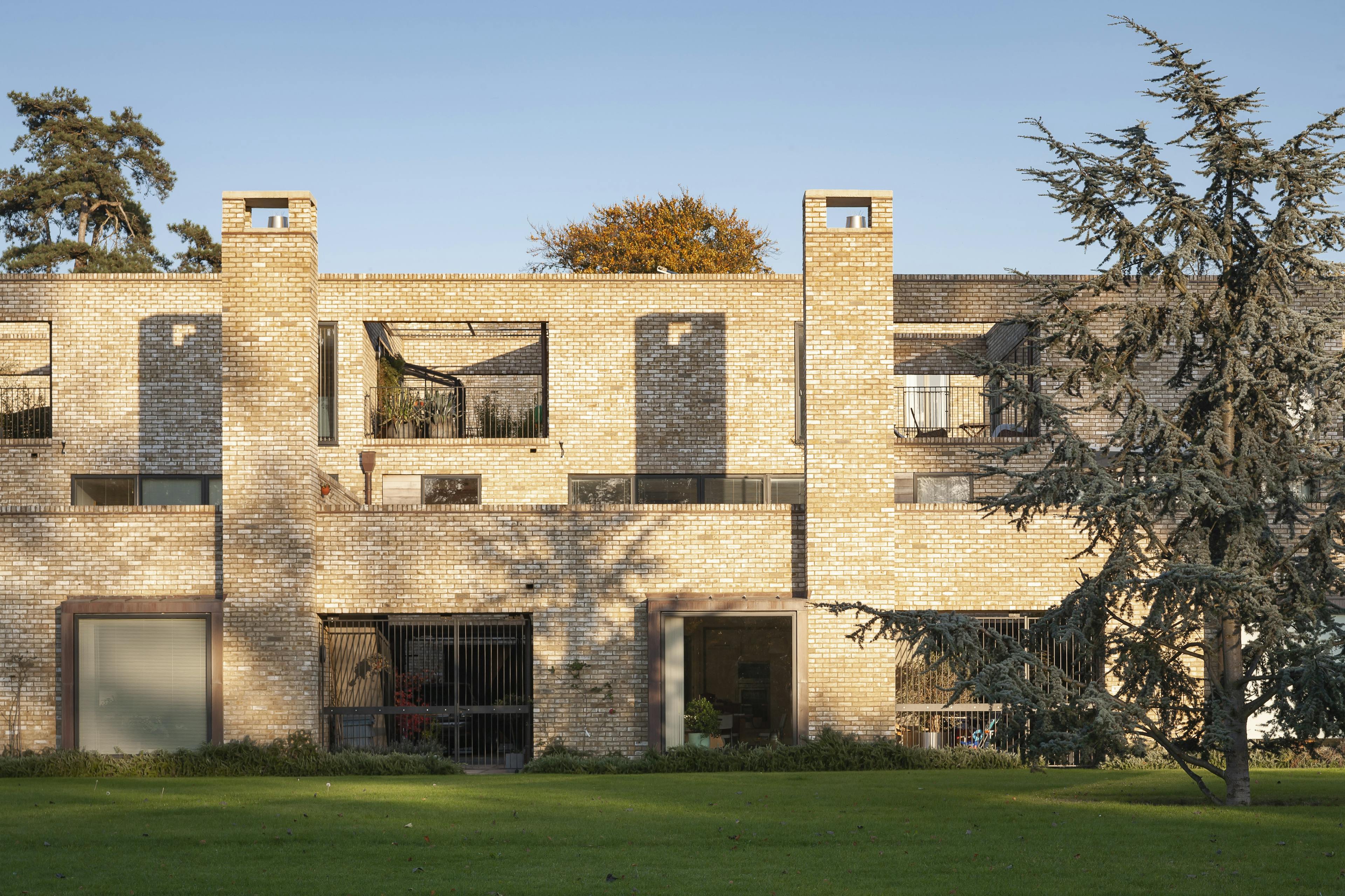 Award-winning modern, sustainable urban living featuring distinctive oak-framed grids that support modular balconies in a new housing project