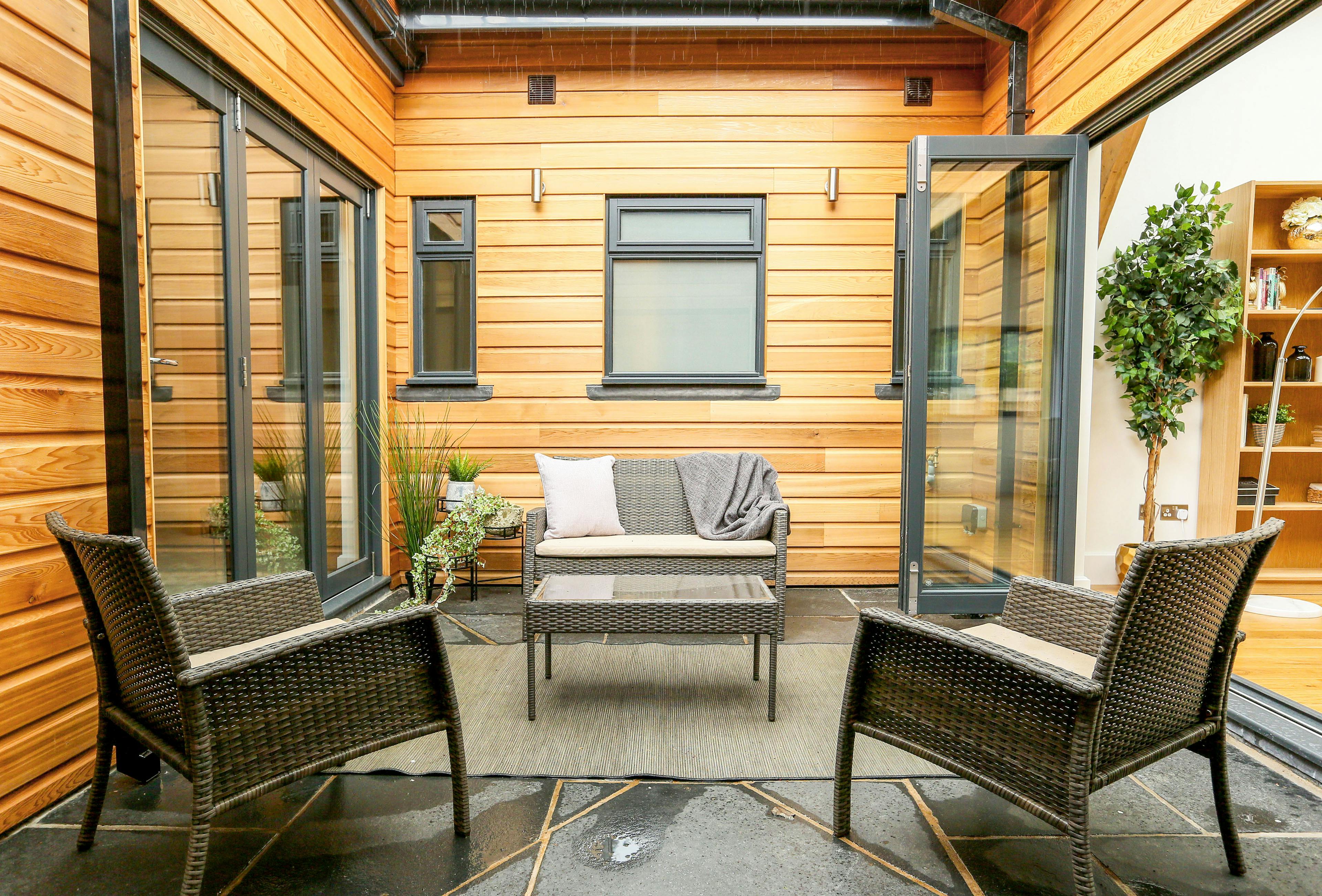 A interior courtyard of an oak framed home with outdoor seating