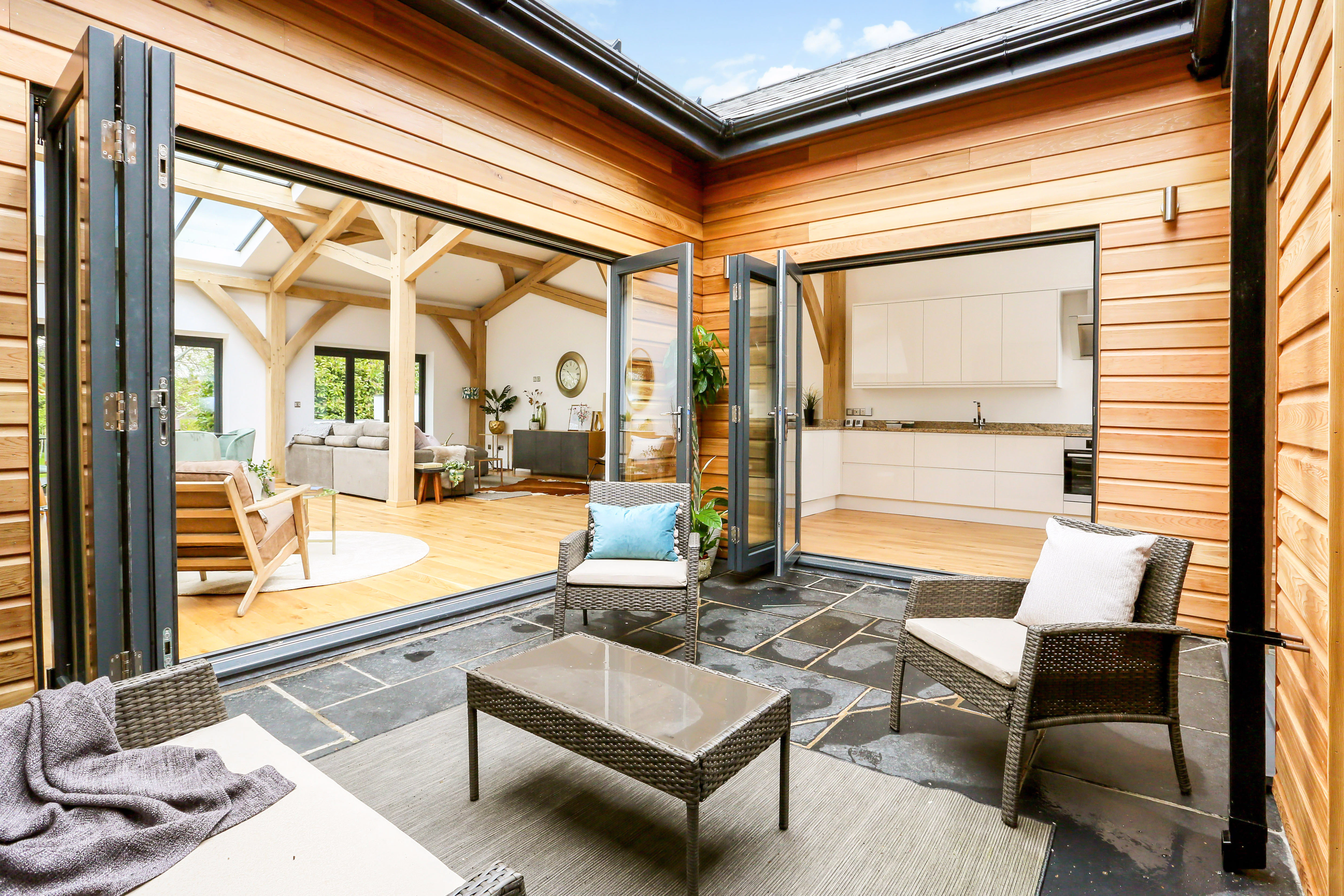 A interior courtyard of an oak framed home with outdoor seating