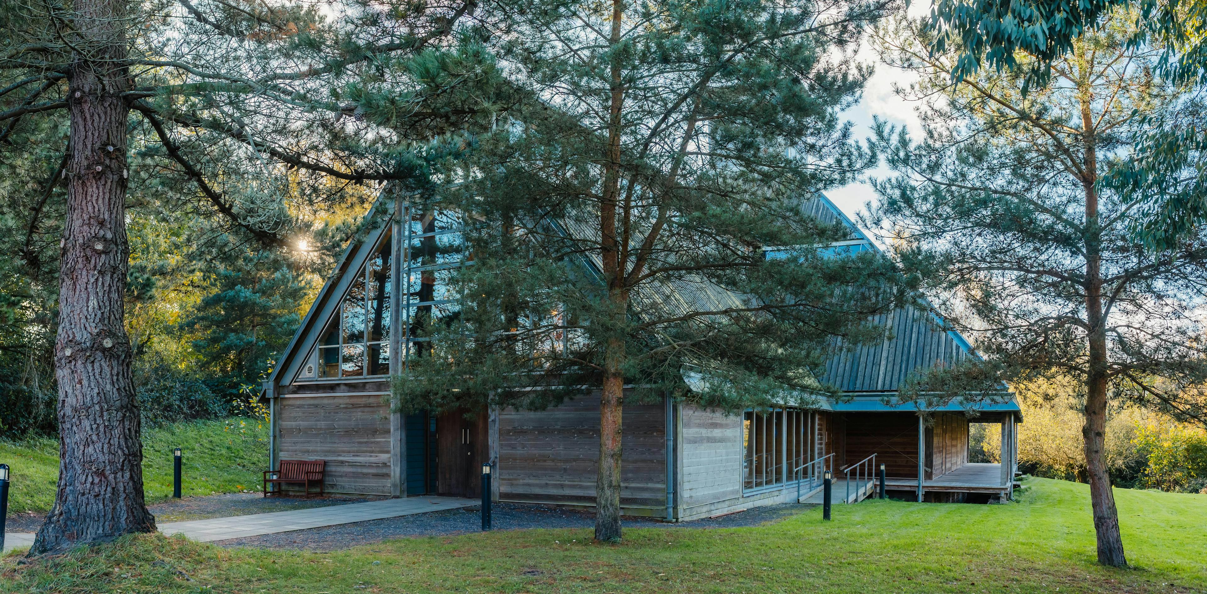 An oak frame theatre seen through some trees