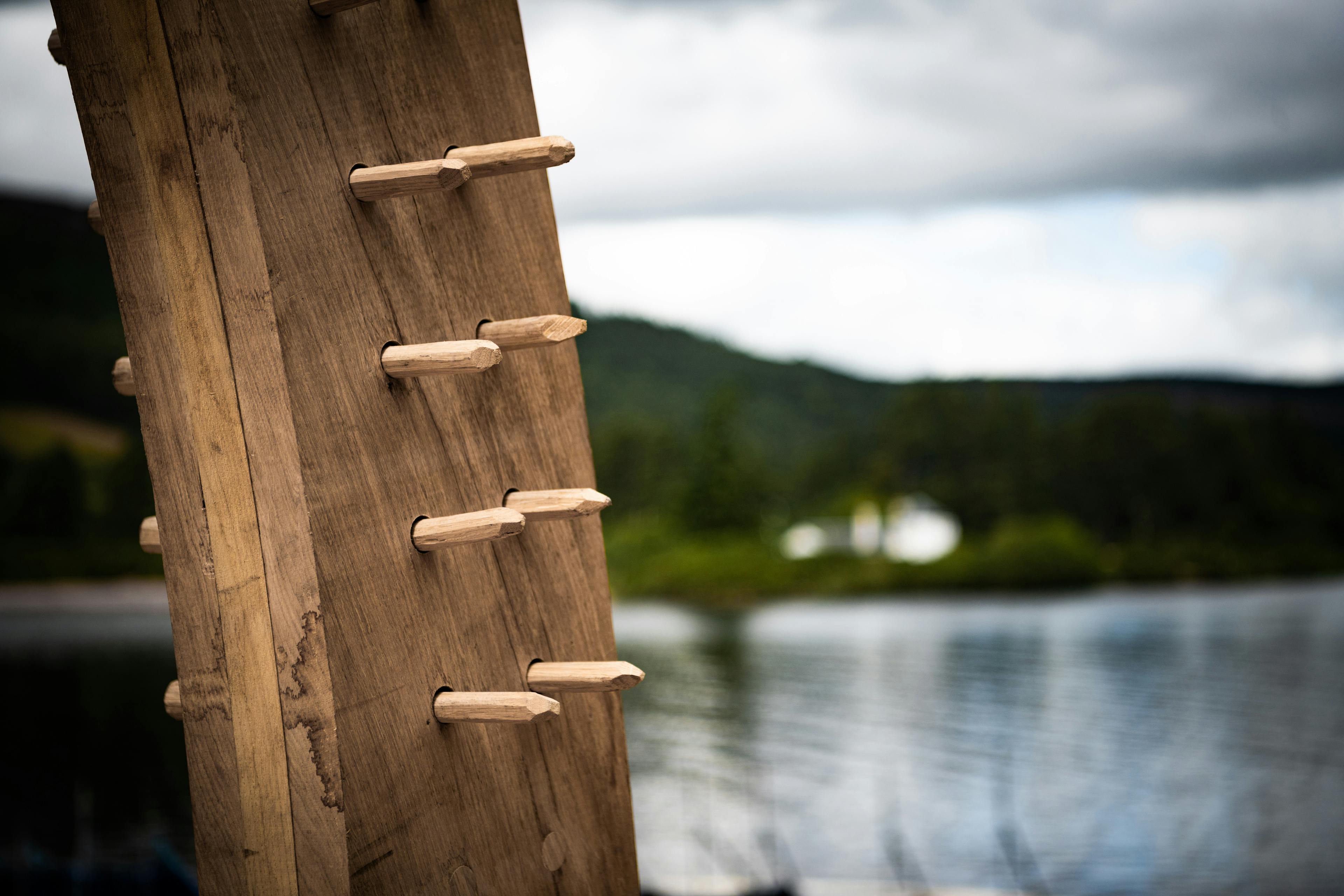 The detail of an oak framed boathouse by a lake during construction