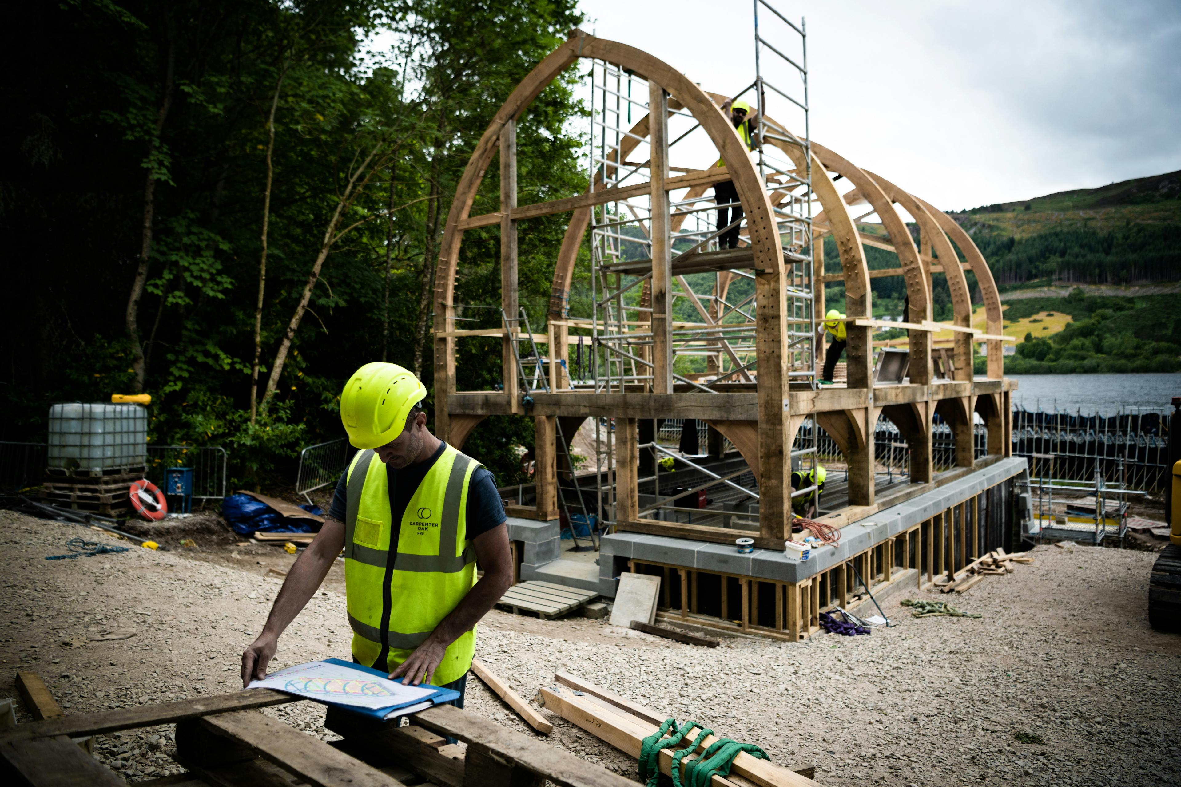 The oak frame of a timber boathouse on loch ness with a curved roof during construction
