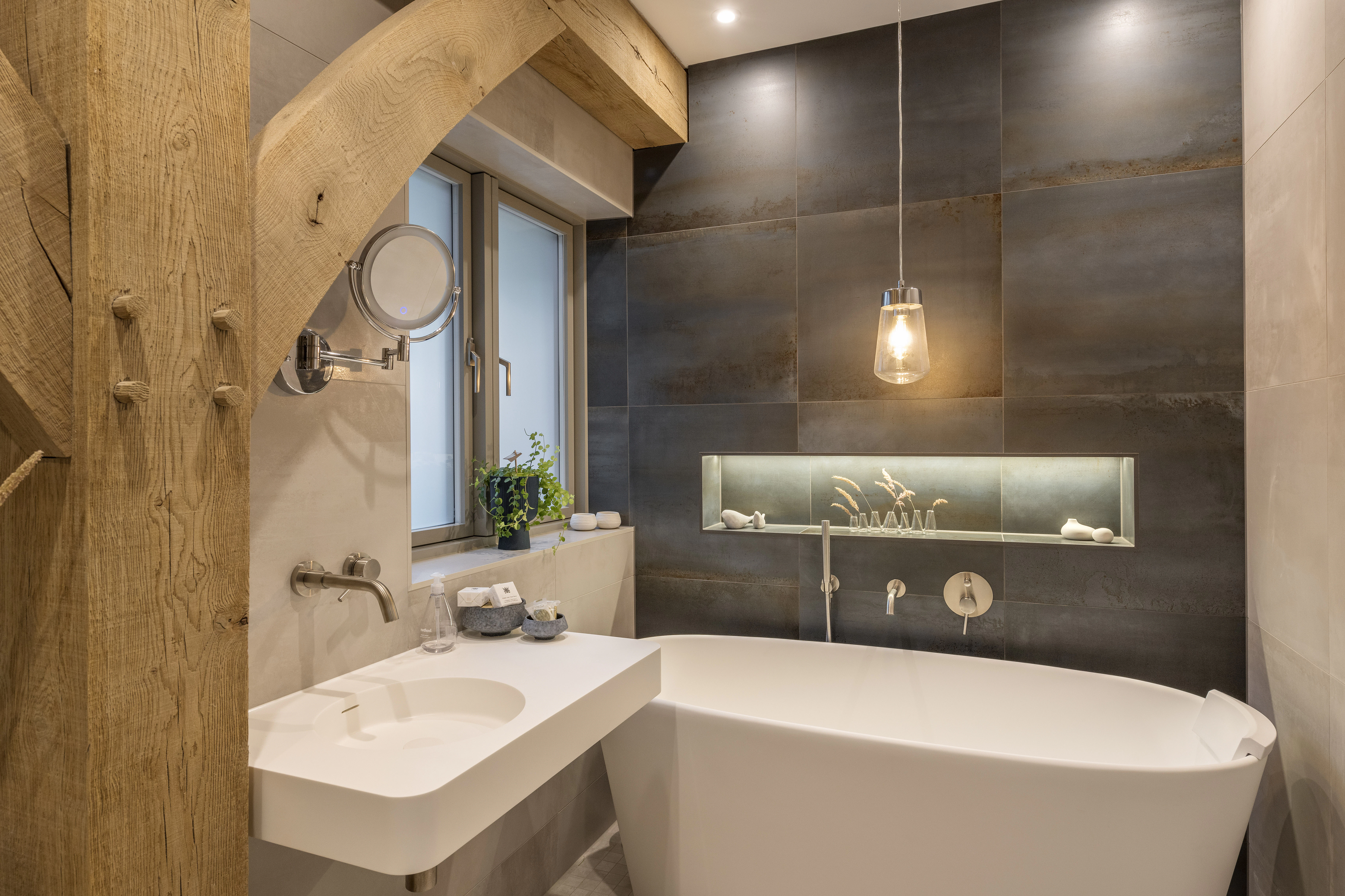 An oak framed bathroom with a white freestanding bath