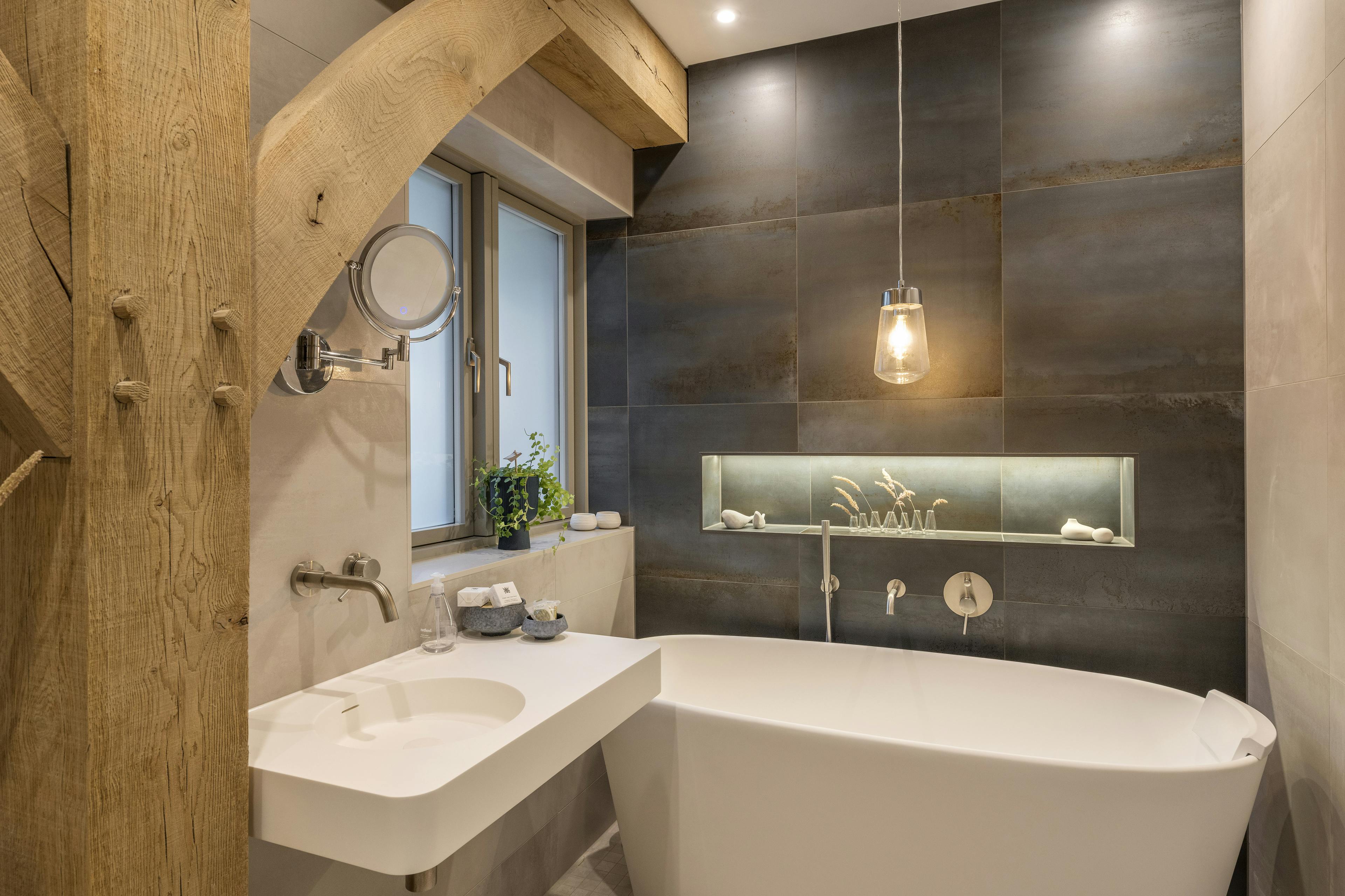 An oak framed bathroom with a white freestanding bath