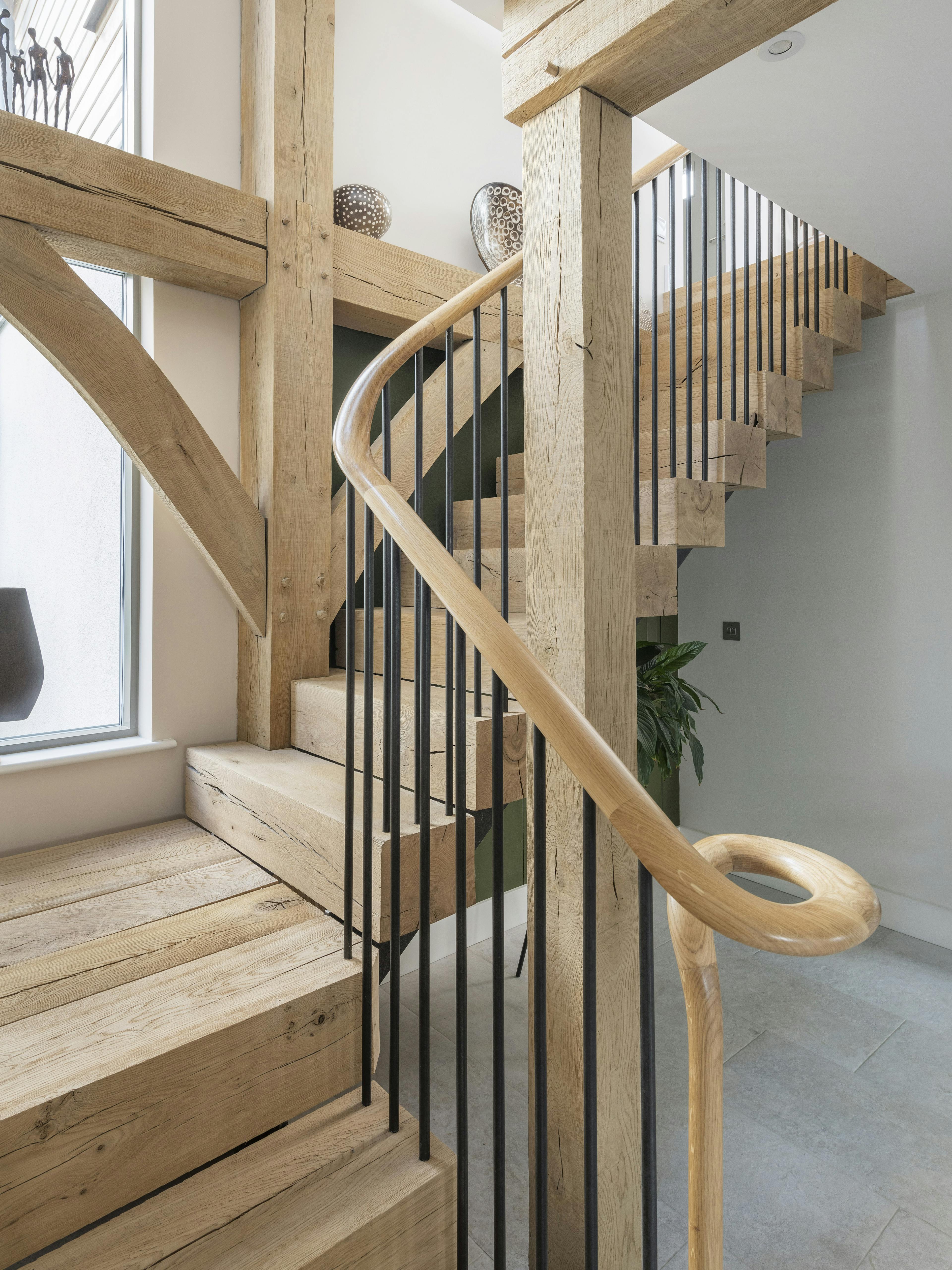 Wooden L shaped stairs nestled into an oak frame