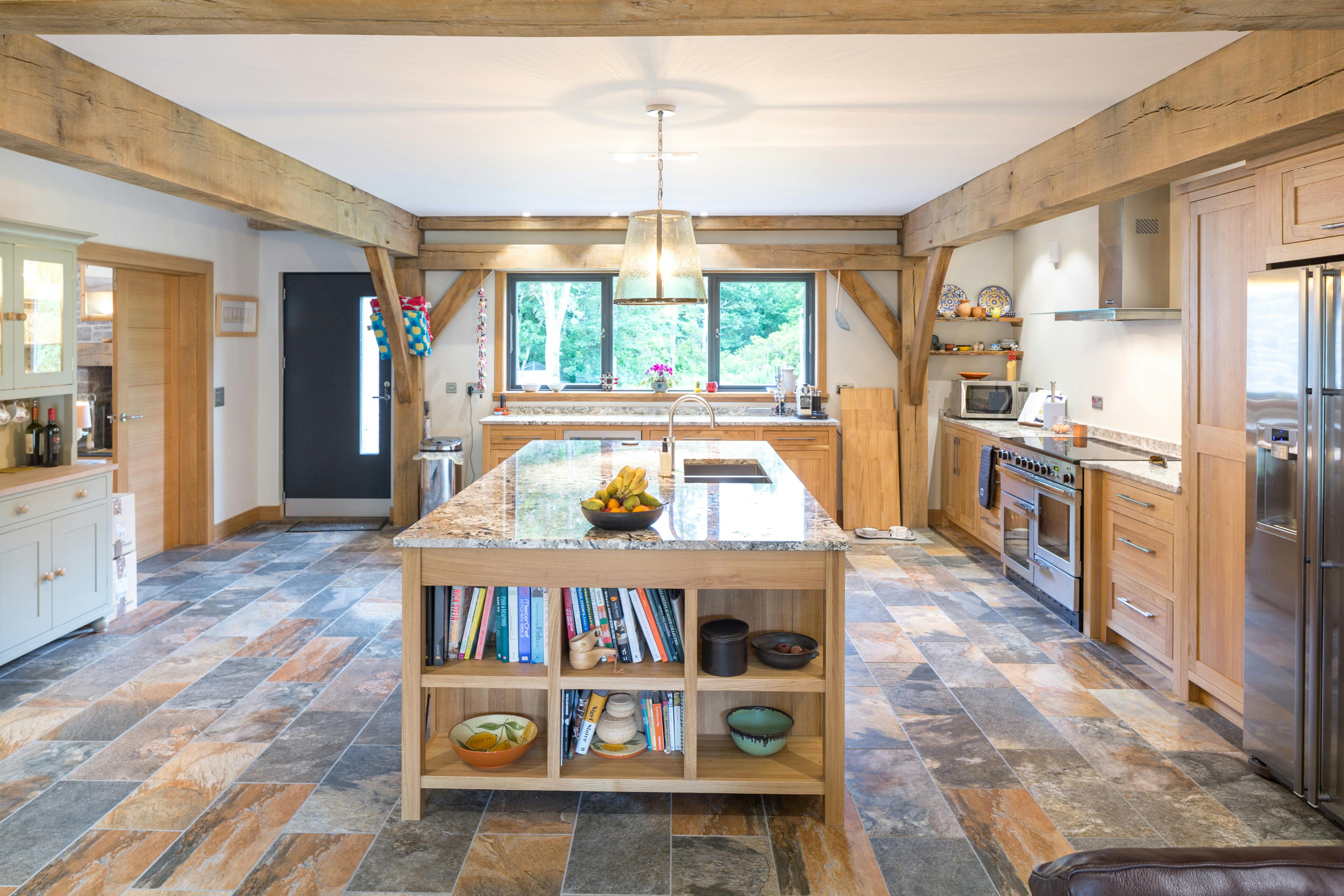 A large oak framed kitchen with an island in the middle
