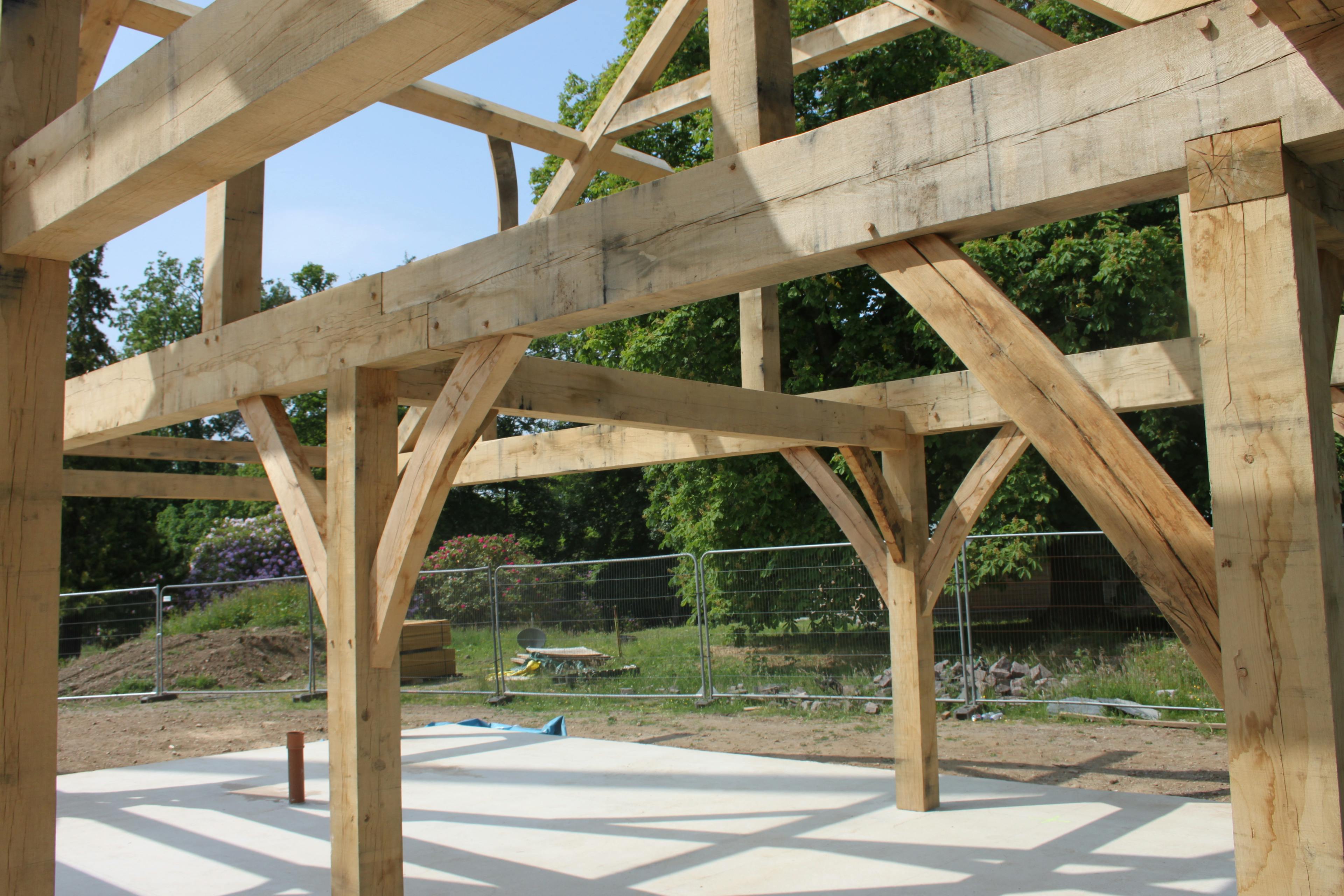 The installation of an oak framed house on a construction site