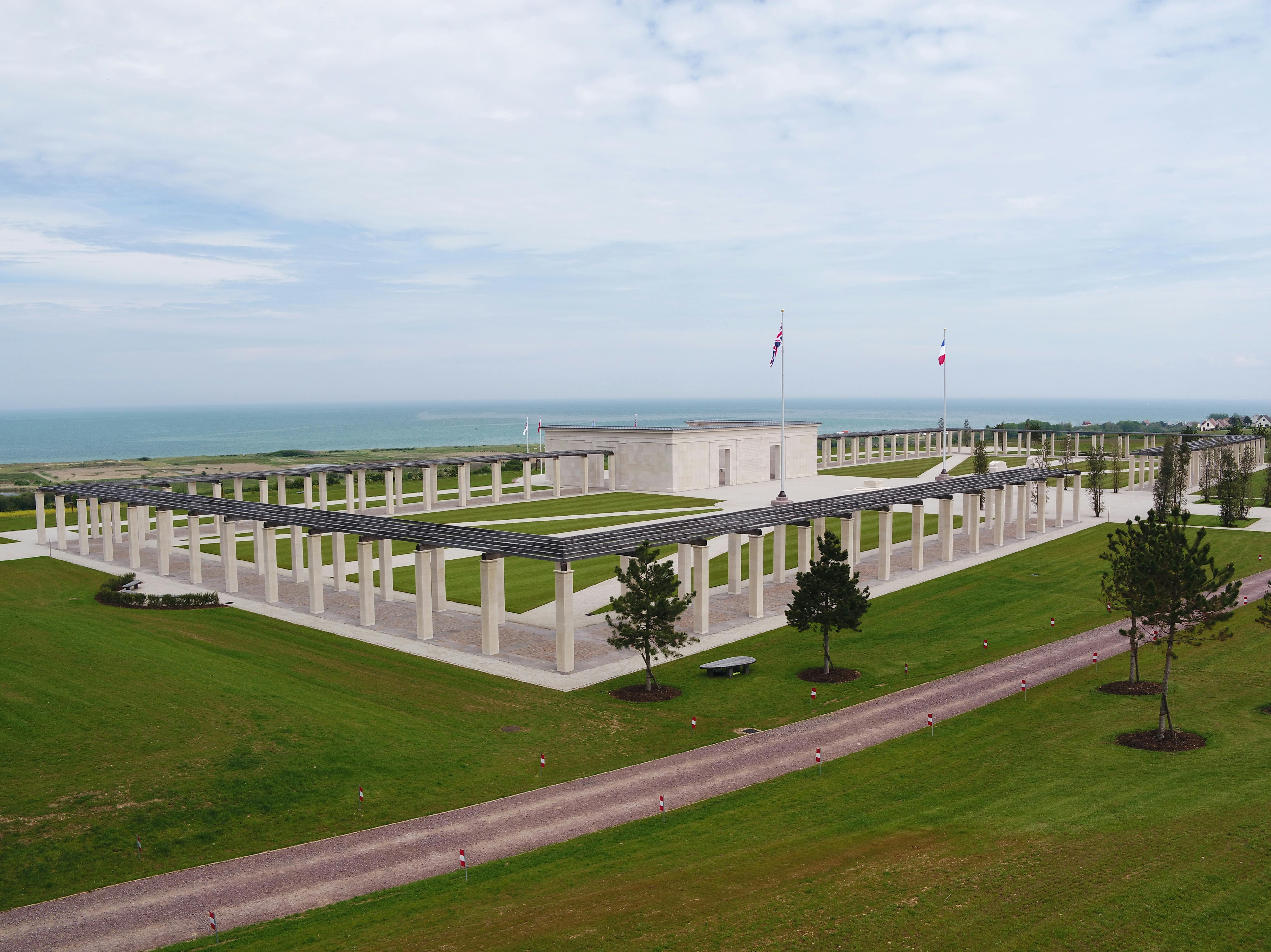 An aerial view of the British Normandy Memorial with the blue sea and sky in the background