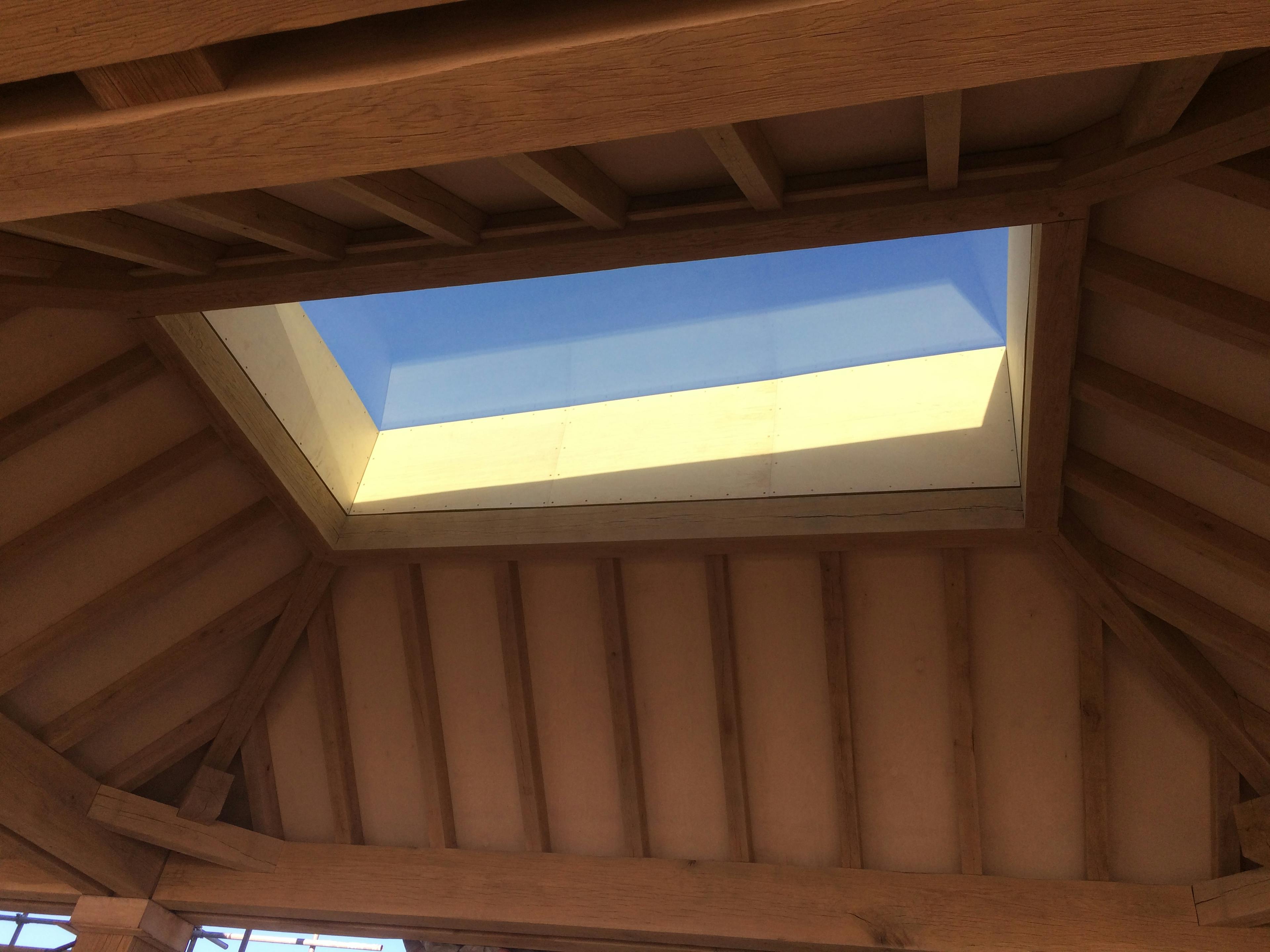 Blue sky can be seen through the top of an oak lantern