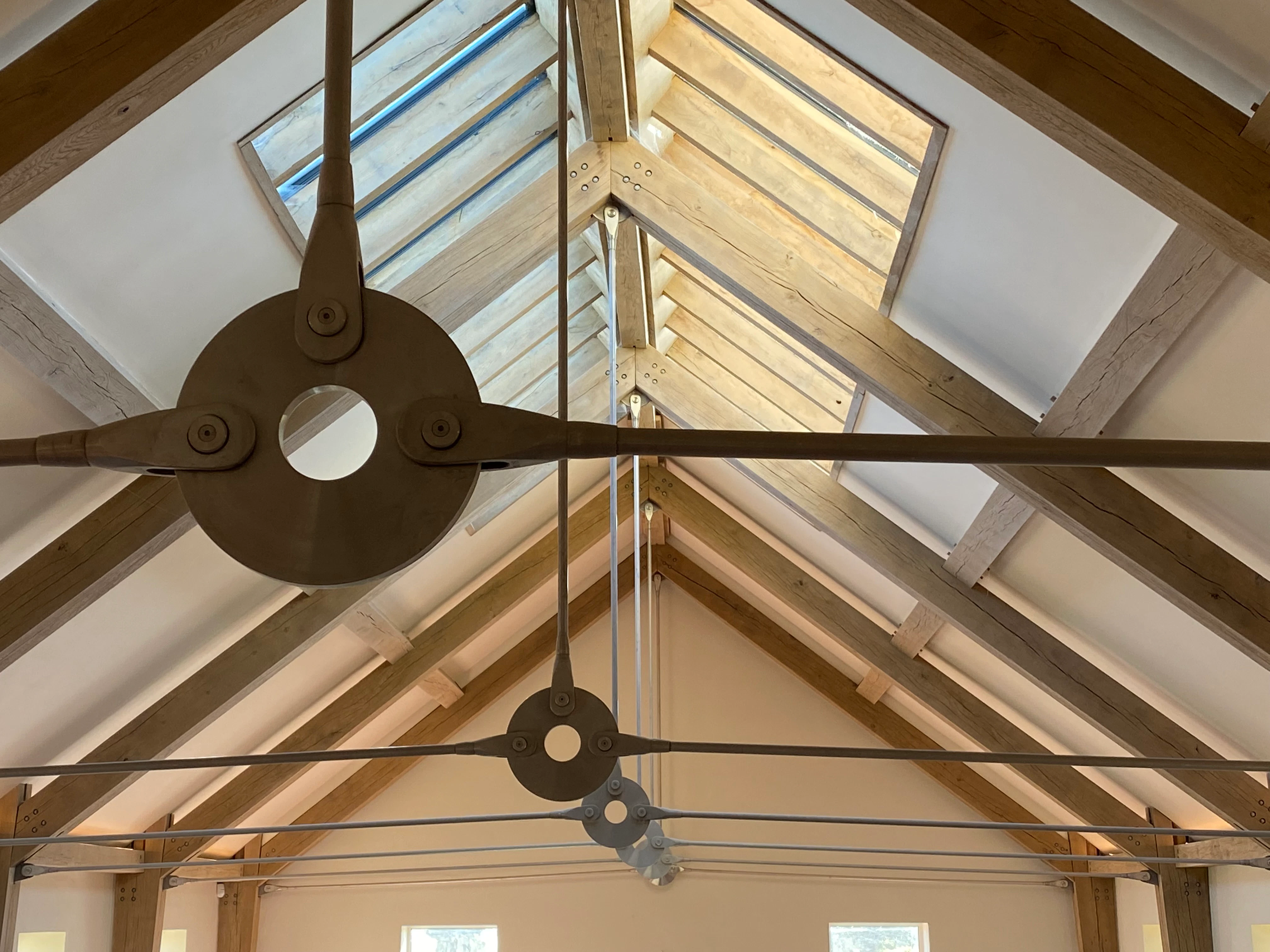 The ceiling of a swimming pool rooflights, showing an oak frame and steel tie connections