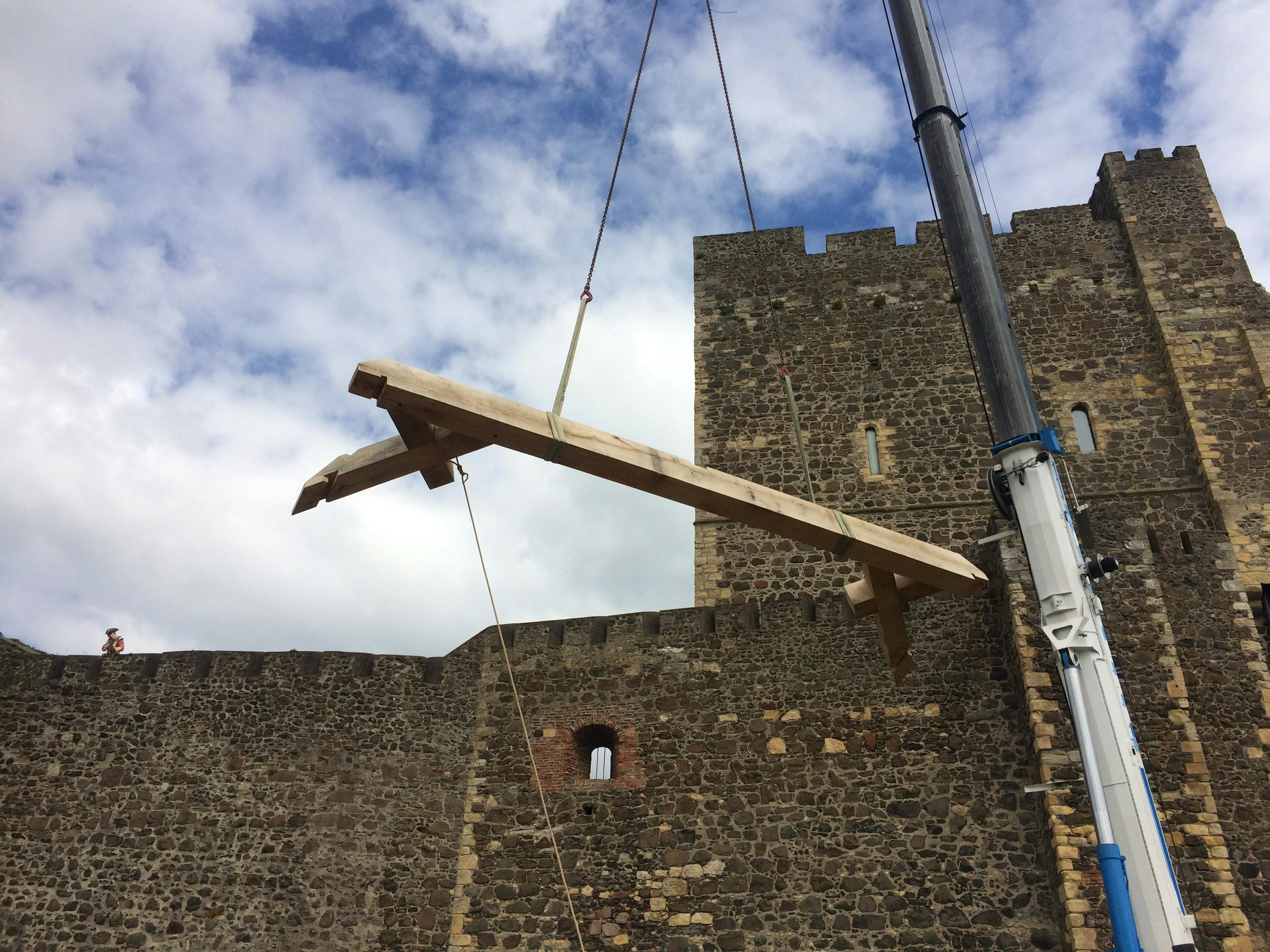 A crane on site lifts a large oak post for the great hall roof at Carrickfergus Castle in Northern Ireland