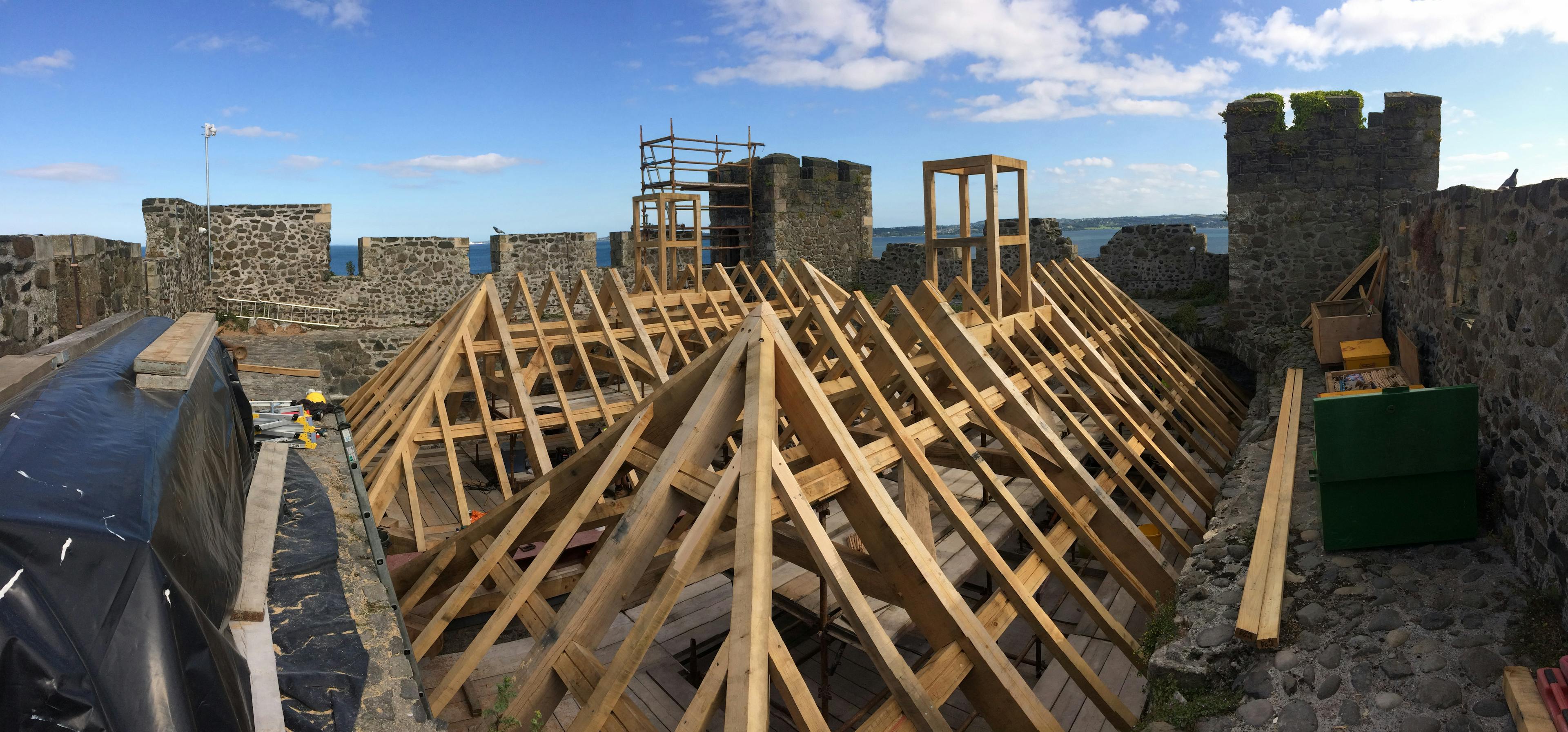 An oak frame at the top of a stone tower of a castle