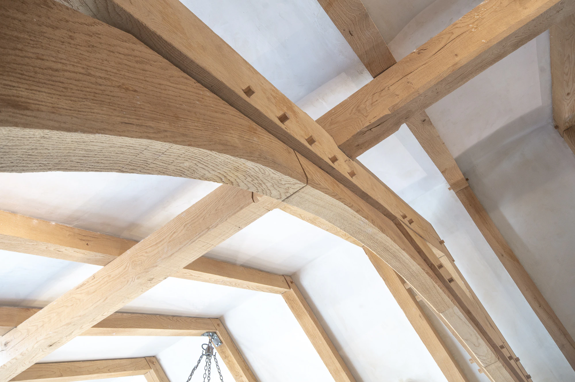 A close up an oak framed truss in a dining room extension to a pub