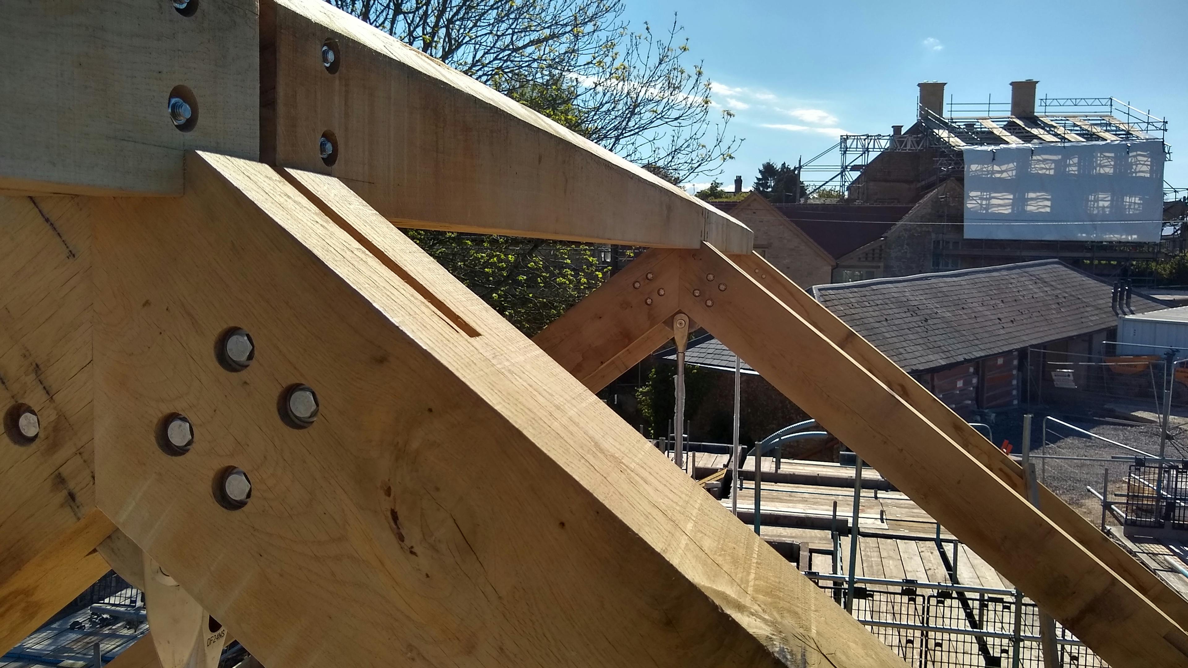 A close up of a truss of an oak frame on a construction site