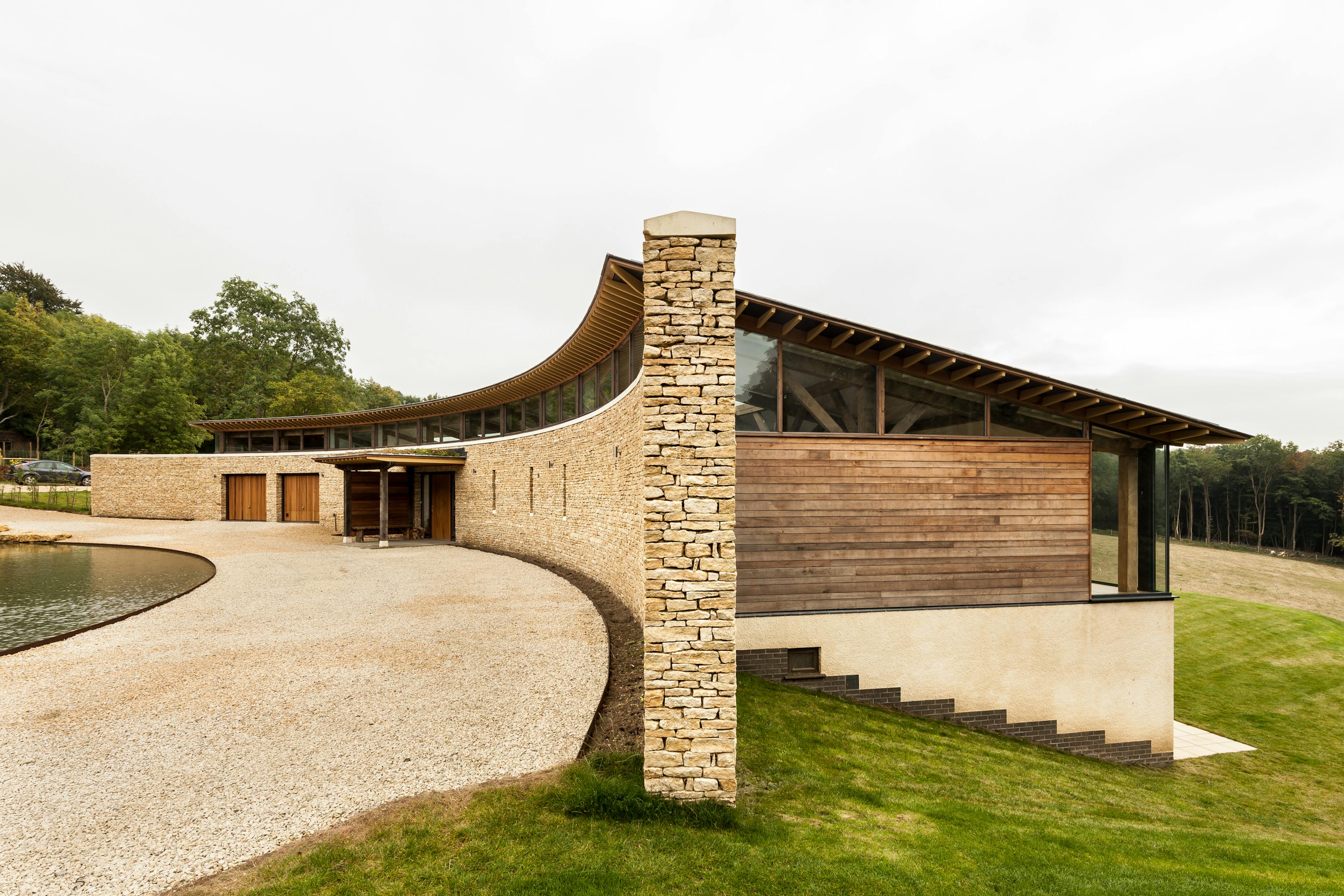A curved oak framed house with stone finished front wall