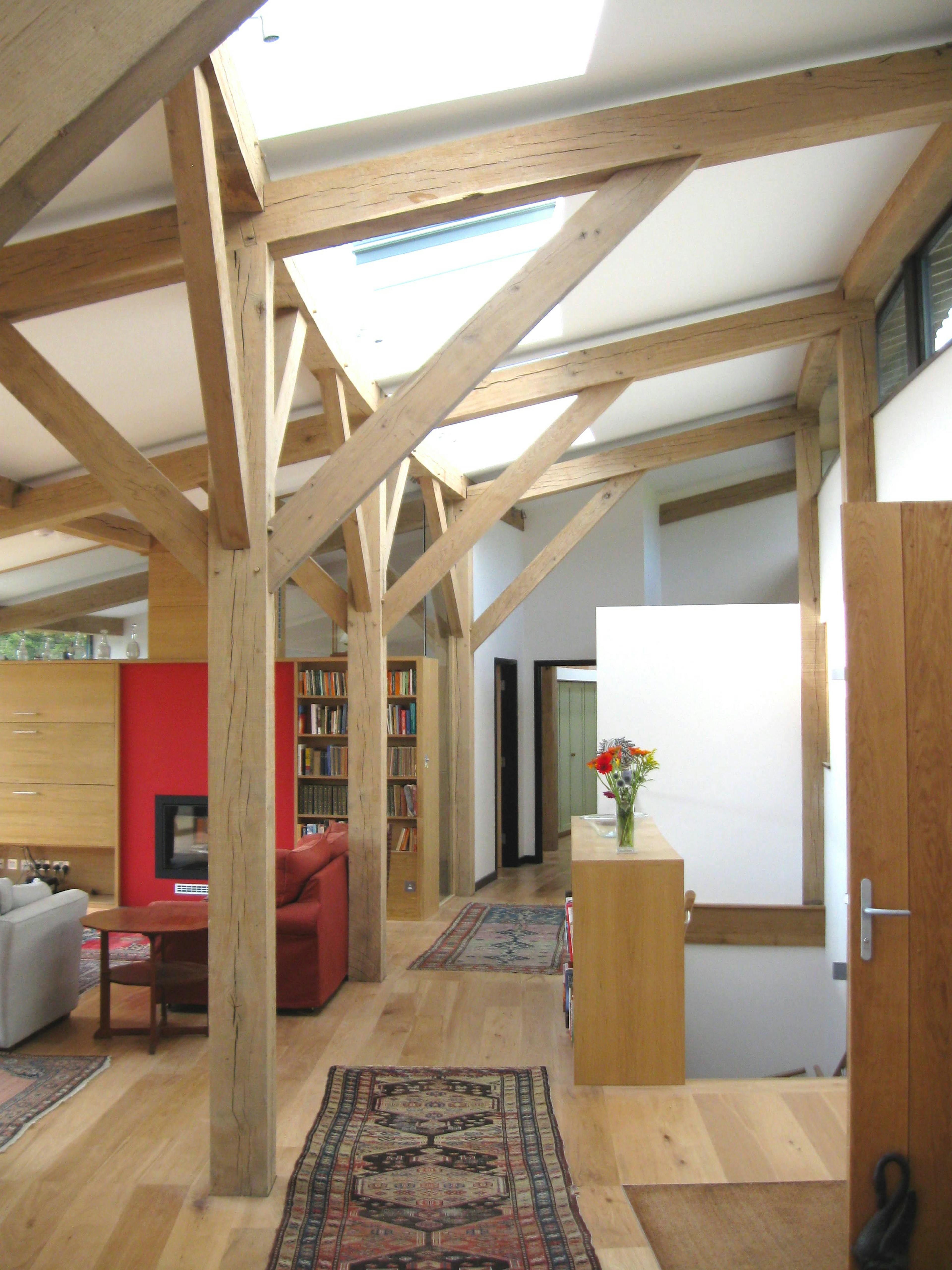 The hallway of a curved oak framed house with rooflights